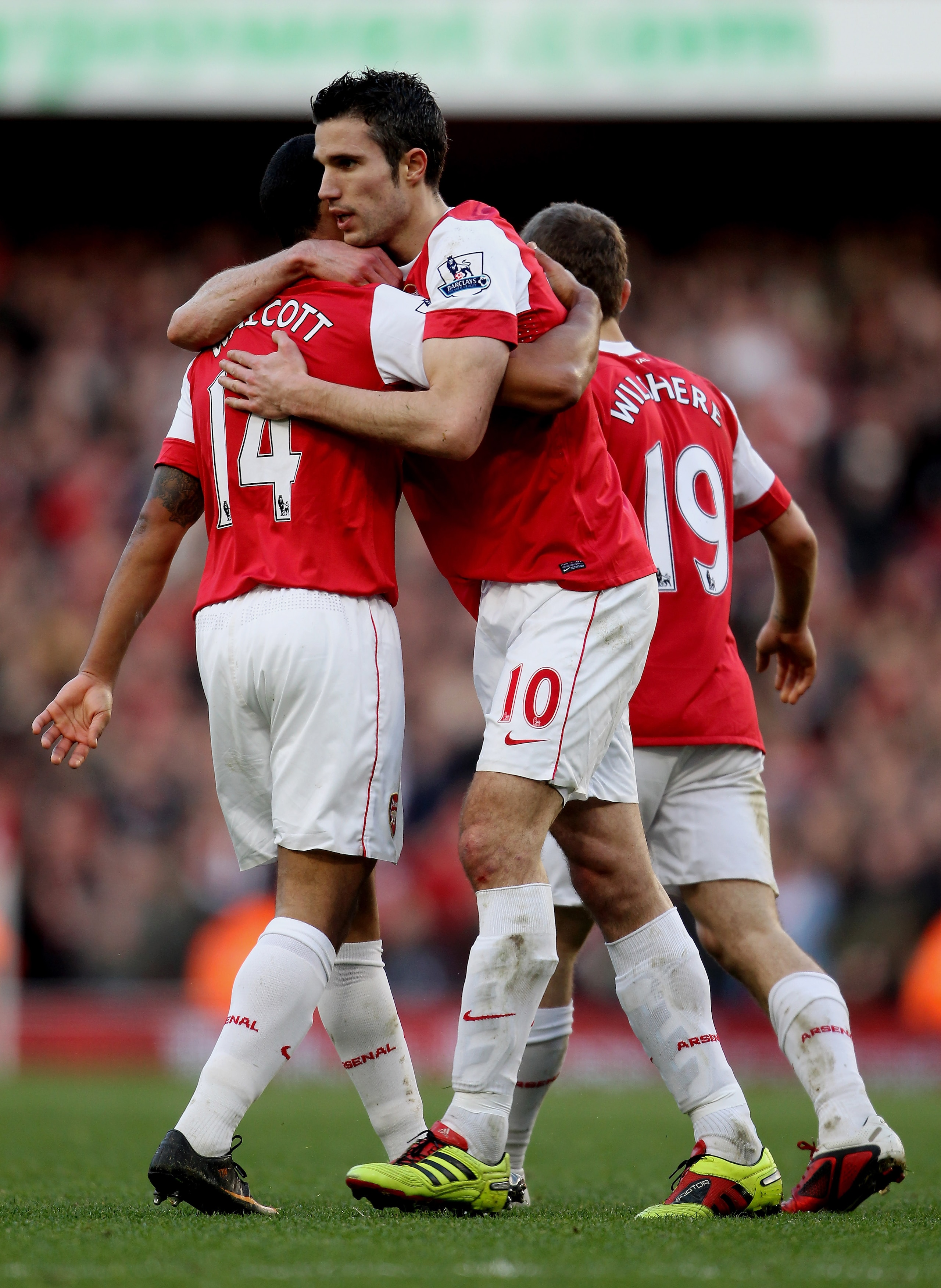 LONDON, ENGLAND - FEBRUARY 12:  Robin Van Persie of Arsenal (R) celebrates with Theo Walcott after scoring their second goal during the Barclays Premier League match between Arsenal and Wolverhampton Wanderers on February 12, 2011 in London, England.  (Ph