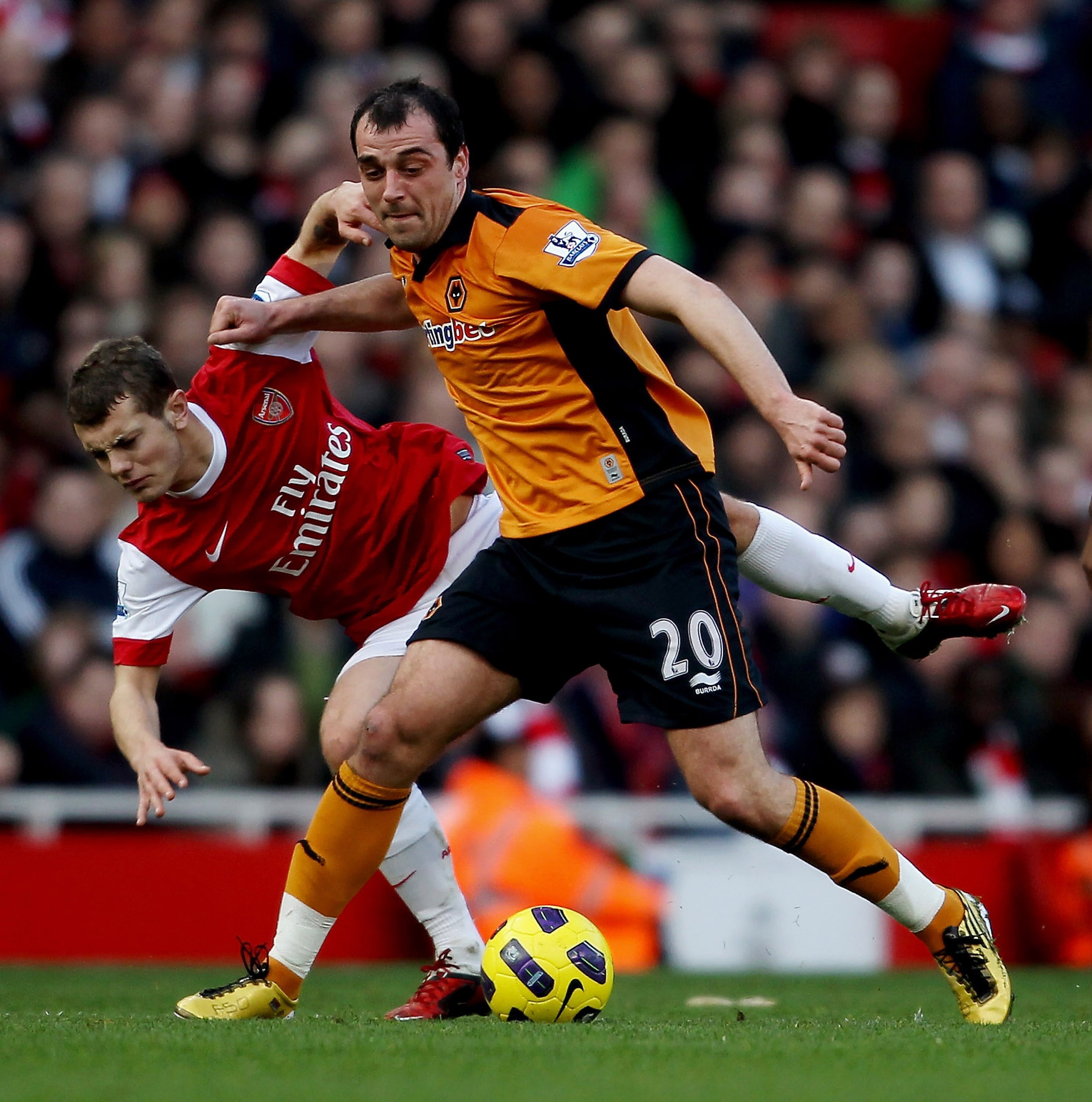 LONDON, ENGLAND - FEBRUARY 12:  Nenad Milijas of Wolves (R) holds off Jack Wilshere of Arsenal during the Barclays Premier League match between Arsenal and Wolverhampton Wanderers on February 12, 2011 in London, England.  (Photo by Scott Heavey/Getty Imag