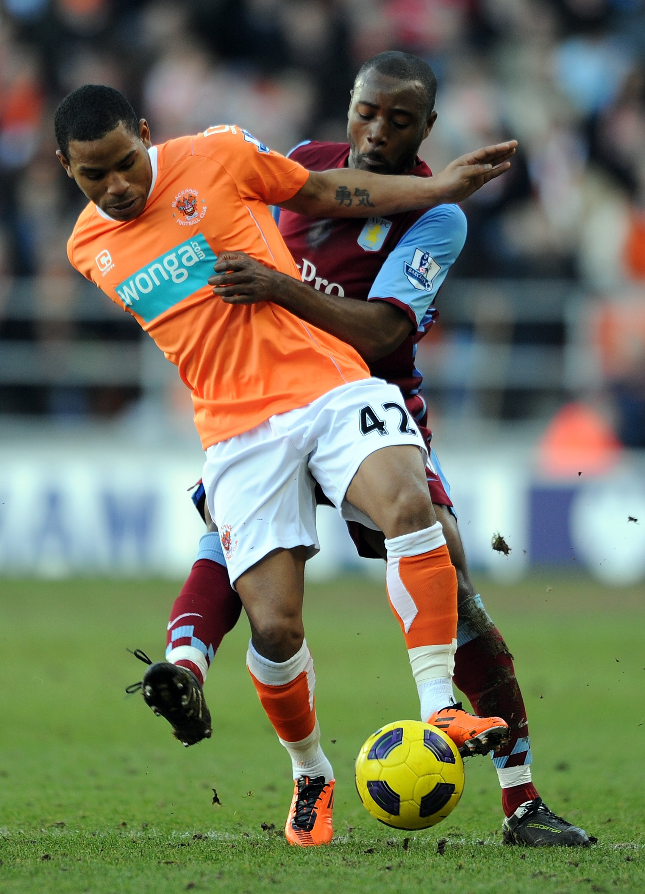 BLACKPOOL, ENGLAND - FEBRUARY 12:  Jason Puncheon of Blackpool competes with Nigel Reo-Coker of Aston Villa during the Barclays Premier League match between Blackpool and Aston Villa at Bloomfield Road on February 12, 2011 in Blackpool, England.  (Photo b