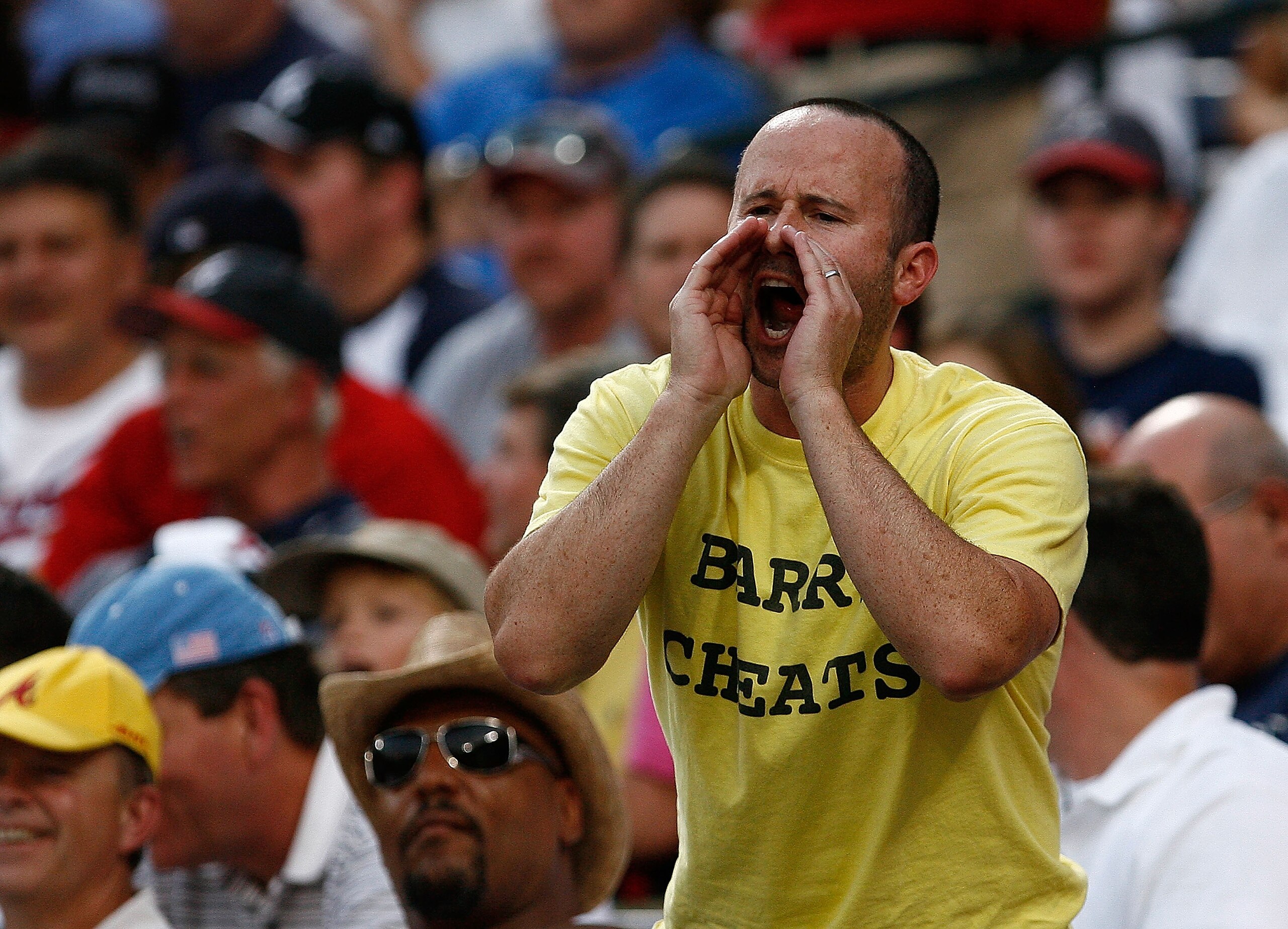 ATLANTA - AUGUST 14:  An unidentified fan yells at Barry Bonds with a 'Barry Cheats' t-shirt on during the game between the Atlanta Braves and the San Francisco Giants at Turner Field August 14, 2007 in Atlanta, Georgia.  (Photo by Mike Zarrilli/Getty Ima
