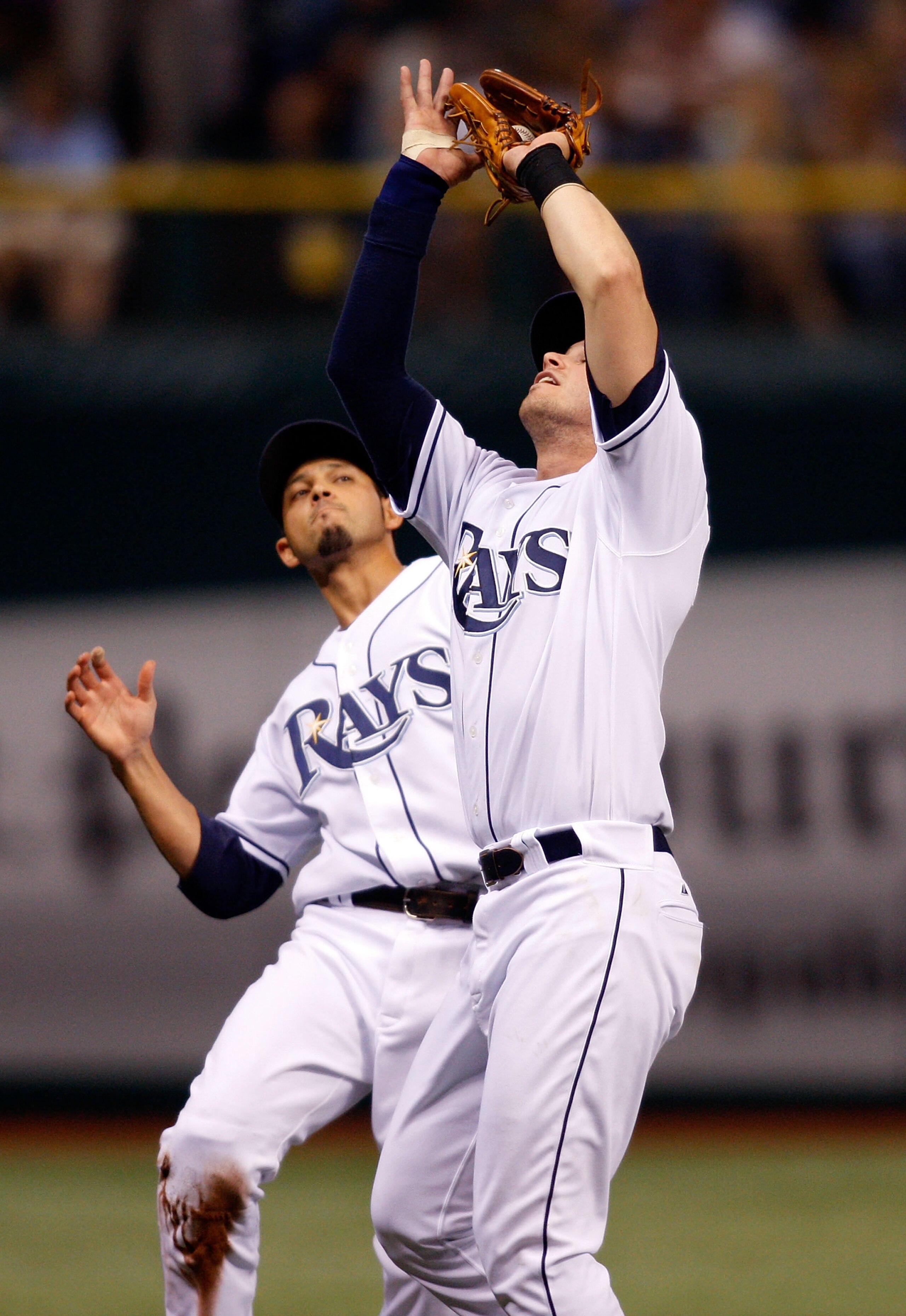 ST. PETERSBURG, FL - SEPTEMBER 19: Infielder Evan Longoria #3 of the Tampa Bay Rays catches a foul ball as shortstop Jason Bartlett #8 is there to back him up against the Minnesota Twins during the game on September 19, 2008 at Tropicana Field in St. Pete