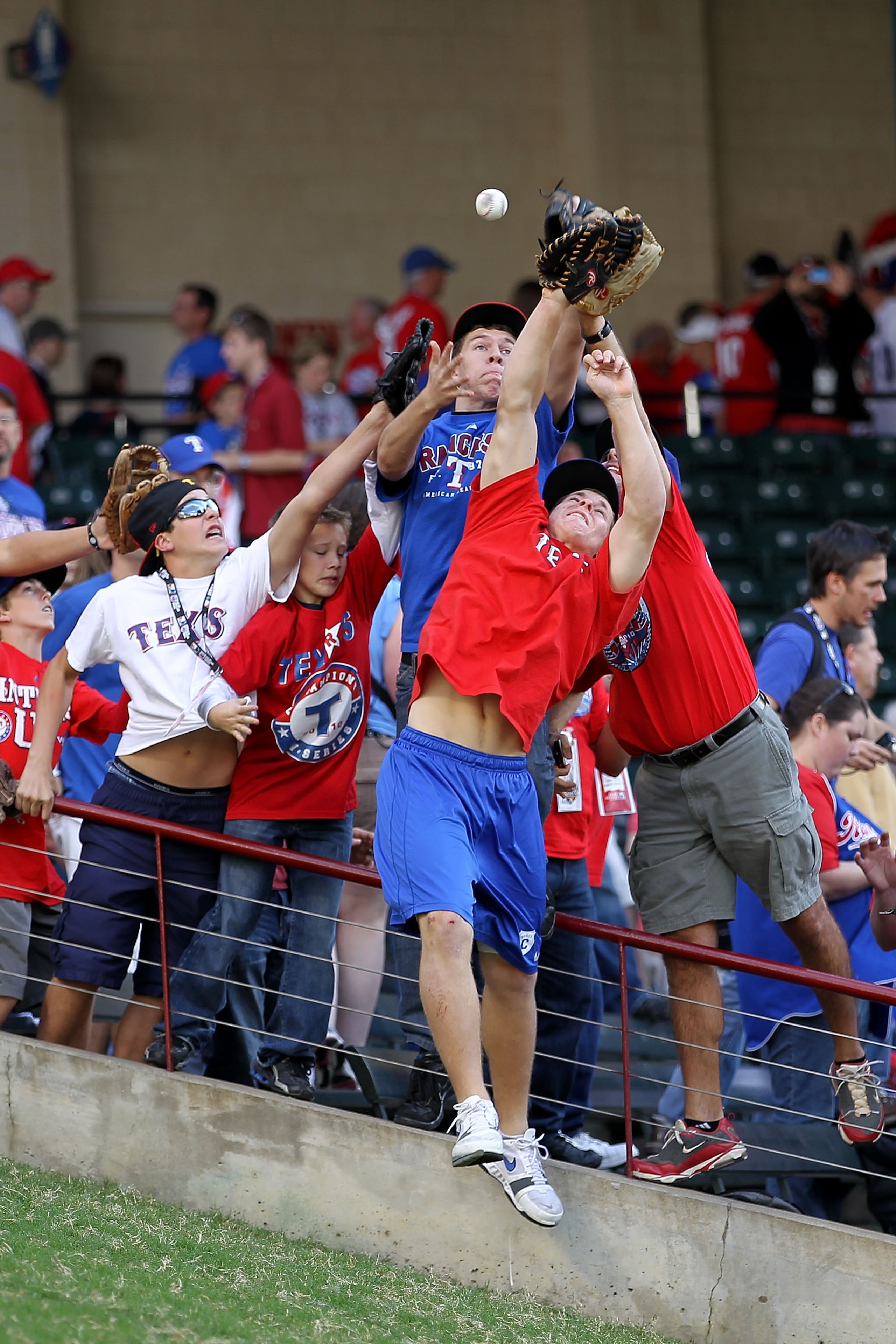 ARLINGTON, TX - NOVEMBER 01:  Fans attempt to catch home run balls during batting practice prior to the Texas Rangers playing against the San Francisco Giants in Game Five of the 2010 MLB World Series at Rangers Ballpark in Arlington on November 1, 2010 i