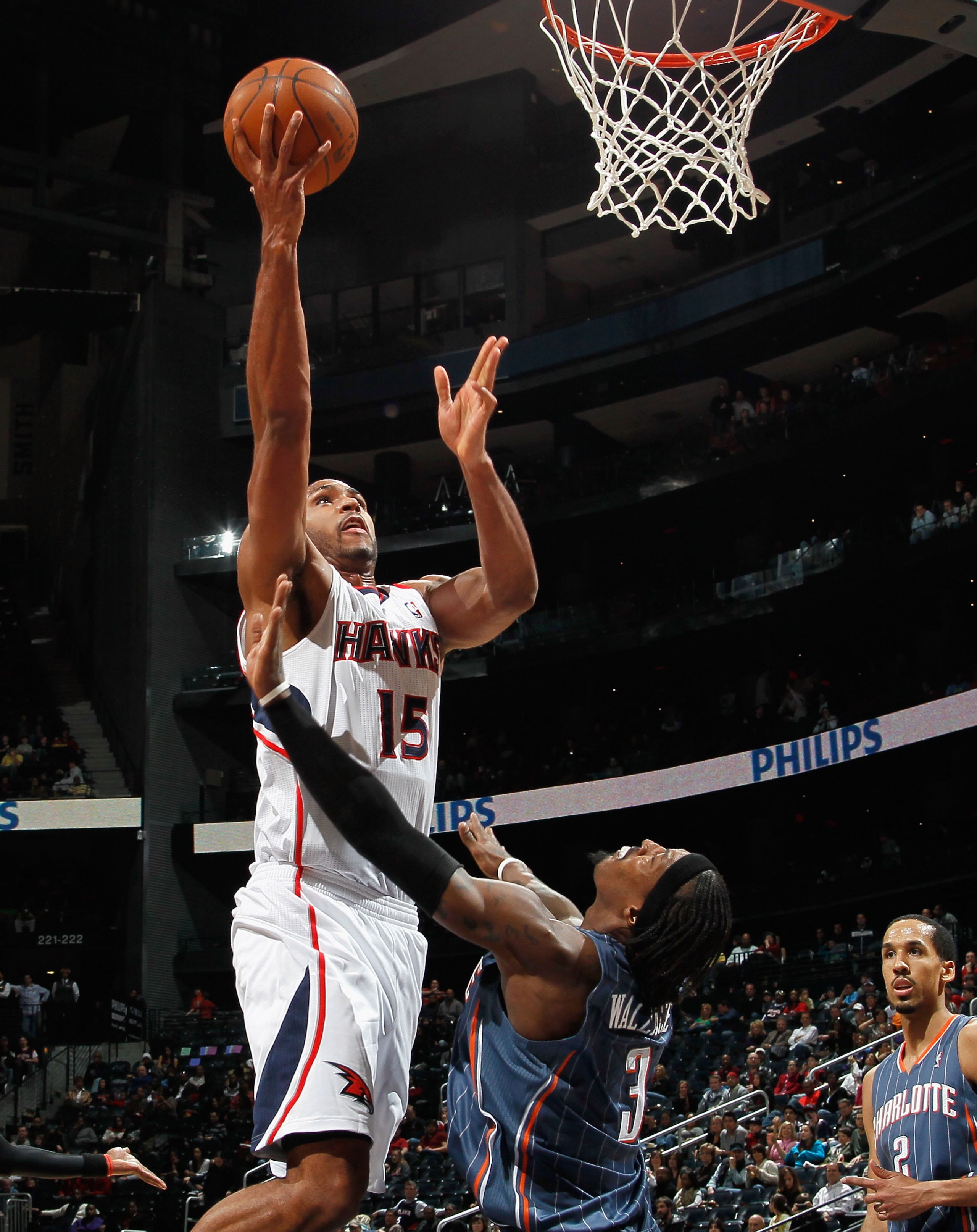 ATLANTA, GA - FEBRUARY 12:  Al Horford #15 of the Atlanta Hawks drives against Gerald Wallace #3 of the Charlotte Bobcats at Philips Arena on February 12, 2011 in Atlanta, Georgia.  NOTE TO USER: User expressly acknowledges and agrees that, by downloading