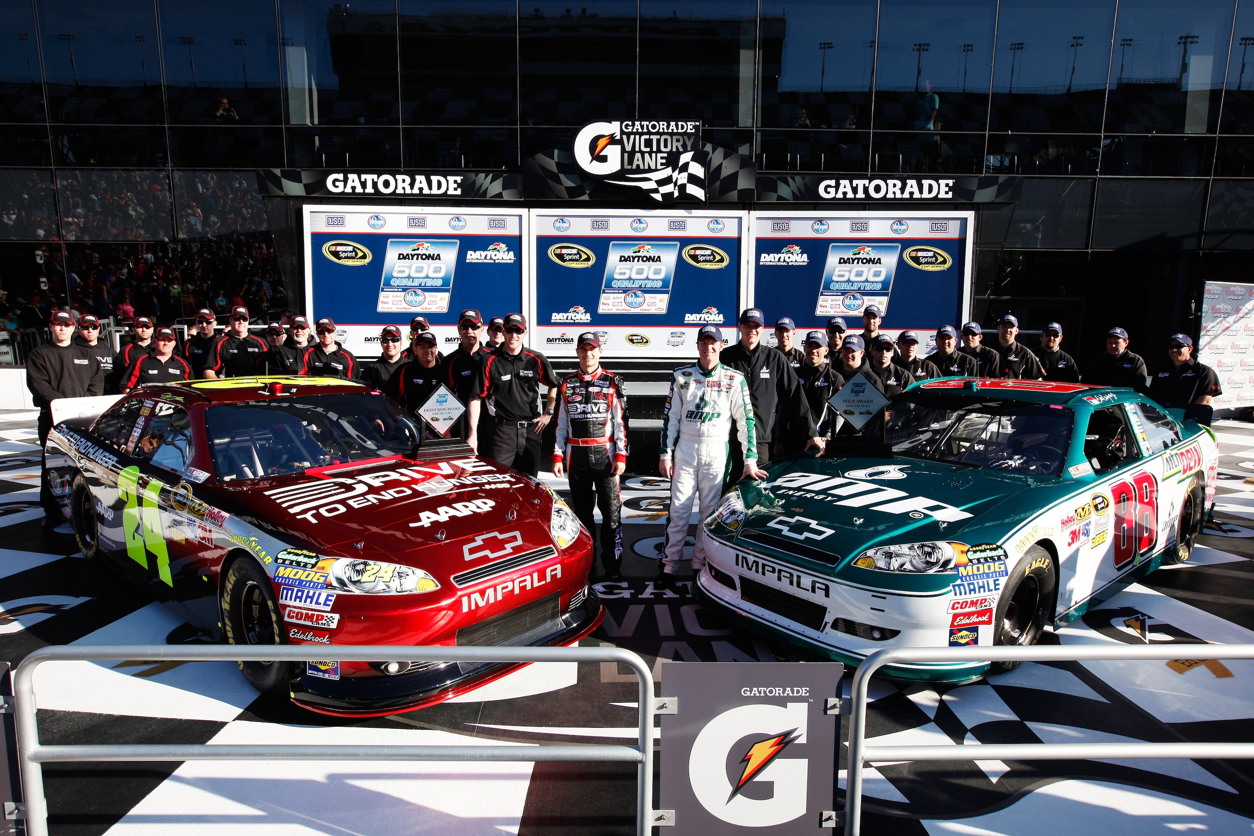 DAYTONA BEACH, FL - FEBRUARY 13:  Front Row award winner Jeff Gordon, driver of the #24 Drive to End Hunger Chevrolet, and Pole award winner Dale Earnhardt Jr., driver of the #88 National Guard/AMP Energy Chevrolet, pose with their teams in victory lane a