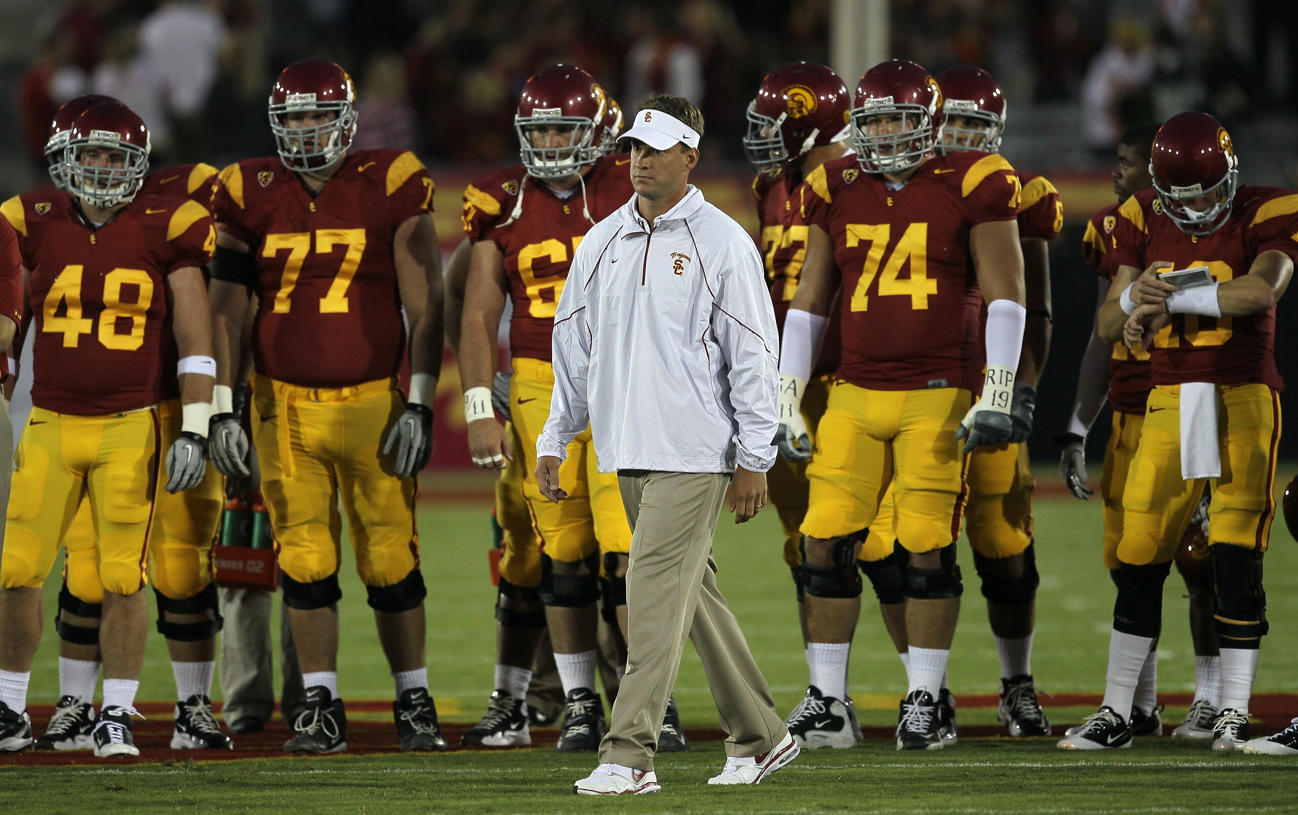 LOS ANGELES, CA - SEPTEMBER 11:  Head coach Lane Kiffin watches the USC Trojans warm up for their game with the Virginia Cavaliers at Los Angeles Memorial Coliseum on September 11, 2010 in Los Angeles, California.  (Photo by Stephen Dunn/Getty Images)