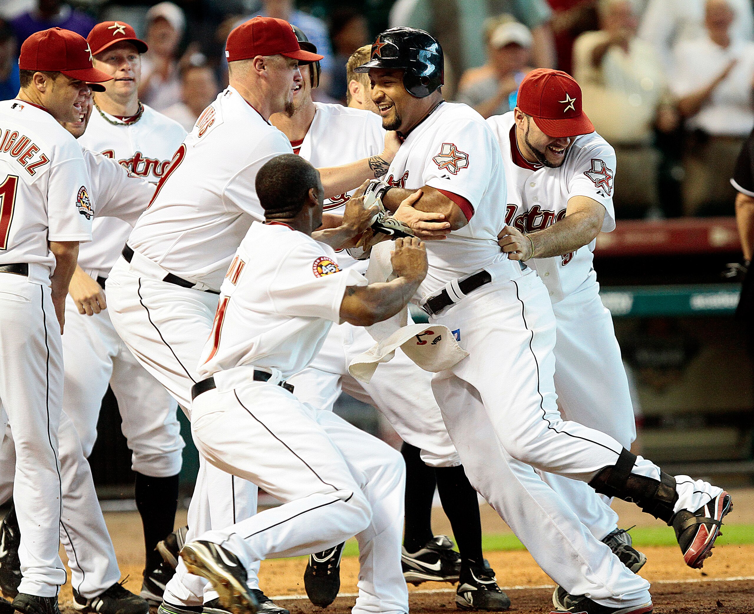 HOUSTON - JUNE 03:  Carlos Lee #45 of the Houston Astros is congratluated at home plate after hitting a two run home run to left field in the bottom of the ninth inning against the Washington Nationals at Minute Maid Park on June 3, 2010 in Houston, Texas