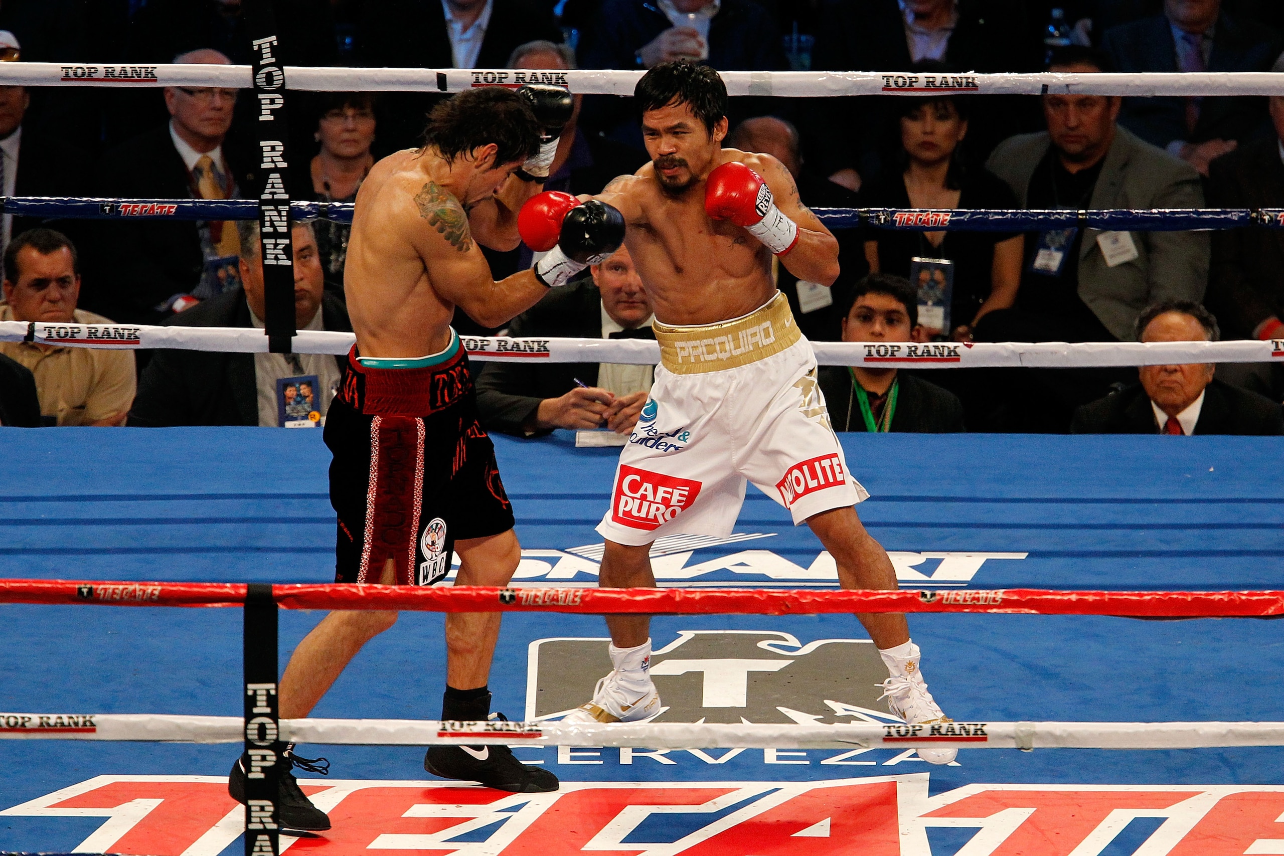 ARLINGTON, TX - NOVEMBER 13: Manny Pacquiao (white trunks) of the Philippines fights against Antonio Margarito (black trunks) of Mexico during their WBC World Super Welterweight Title bout at Cowboys Stadium on November 13, 2010 in Arlington, Texas. (Ph ARLINGTON, TX - NOVEMBER 13: Manny Pacquiao (white trunks) of the Philippines fights against Antonio Margarito (black trunks) of Mexico during their WBC World Super Welterweight Title bout at Cowboys Stadium on November 13, 2010 in Arlington, Texas. (Ph