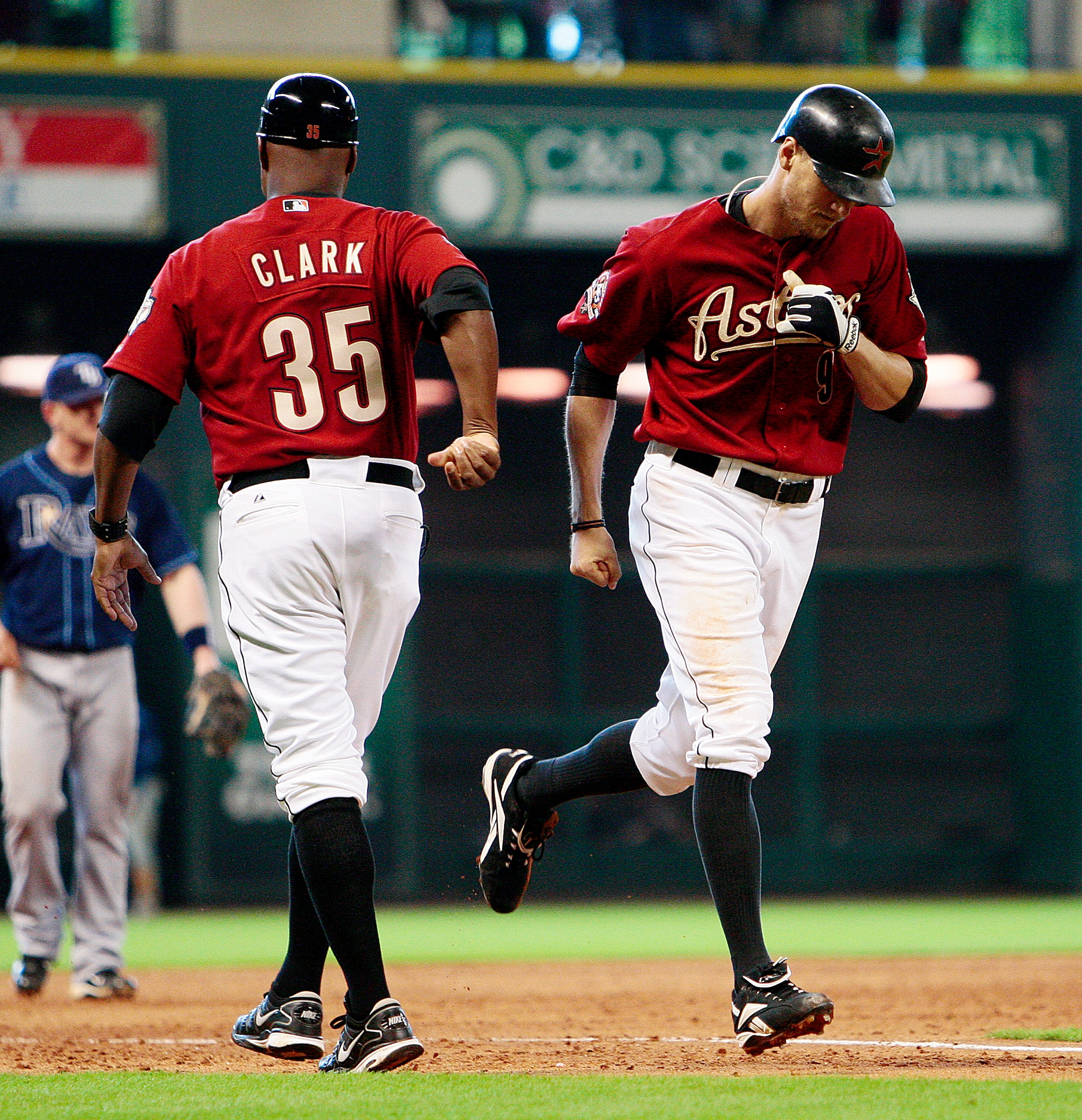 HOUSTON - MAY 23:  Hunter Pence #9 of the Houston Astros receives congratulations from third base coach Dave Clark after hitting a  home run in the fifth inning against the Tampa Bay Rays at Minute Maid Park on May 23, 2010 in Houston, Texas.  (Photo by B
