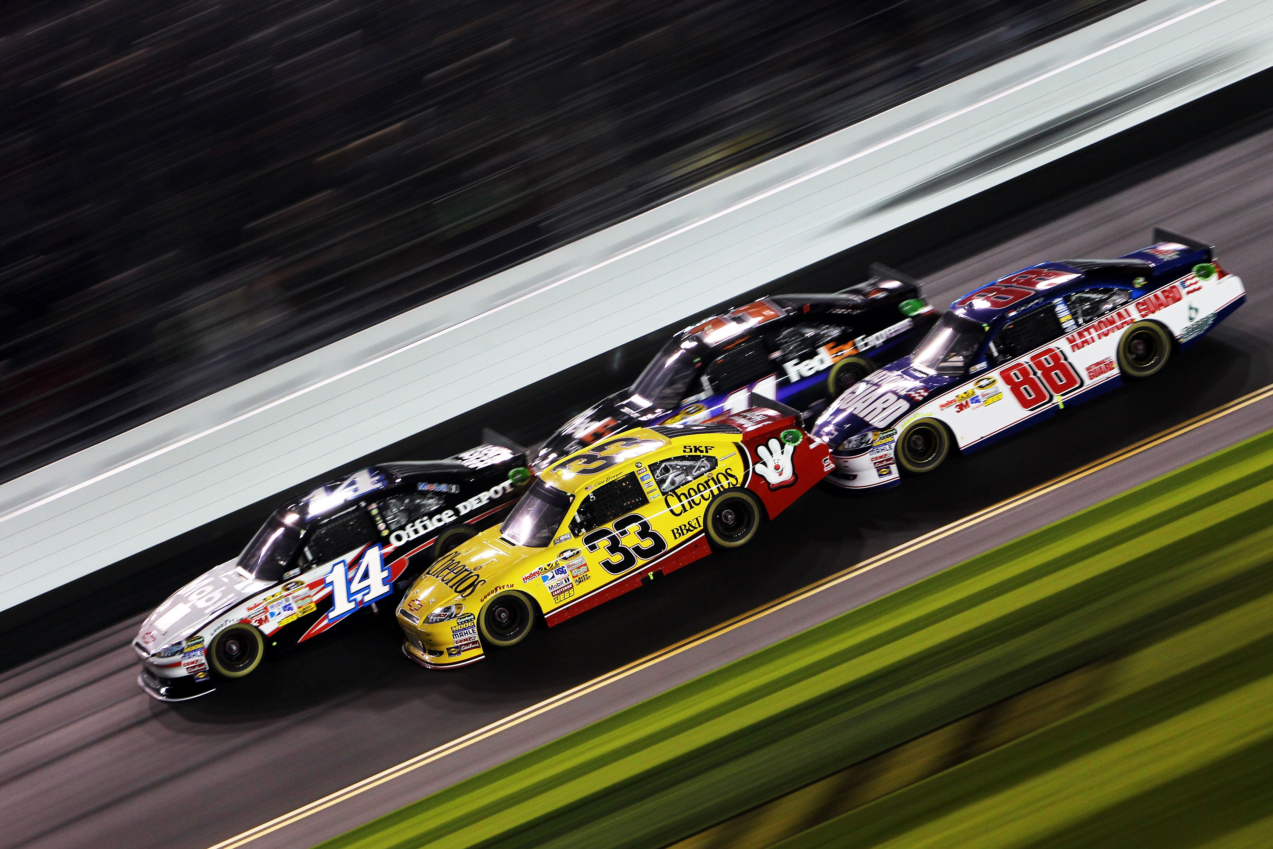 DAYTONA BEACH, FL - FEBRUARY 12:  Tony Stewart, driver of the #14 Mobil 1/Office Depot Chevrolet, leads Clint Bowyer, driver of the #33 Cheerios Chevrolet, Denny Hamlin, driver of the #11 FedEx Toyota, and Dale Earnhardt Jr., driver of the #88 National Gu