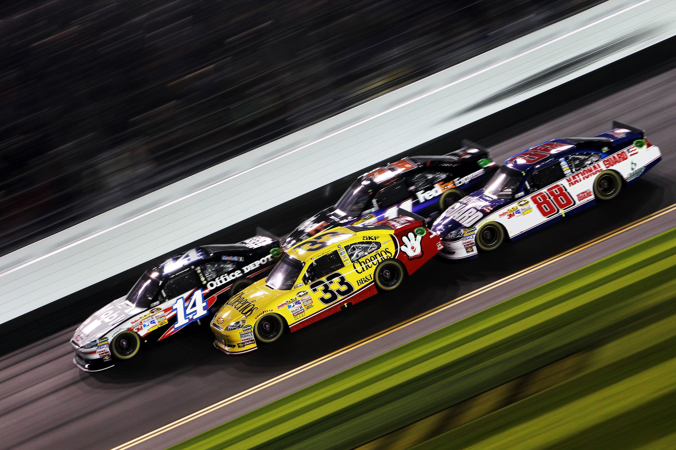 DAYTONA BEACH, FL - FEBRUARY 12:  Tony Stewart, driver of the #14 Mobil 1/Office Depot Chevrolet, leads Clint Bowyer, driver of the #33 Cheerios Chevrolet, Denny Hamlin, driver of the #11 FedEx Toyota, and Dale Earnhardt Jr., driver of the #88 National Gu