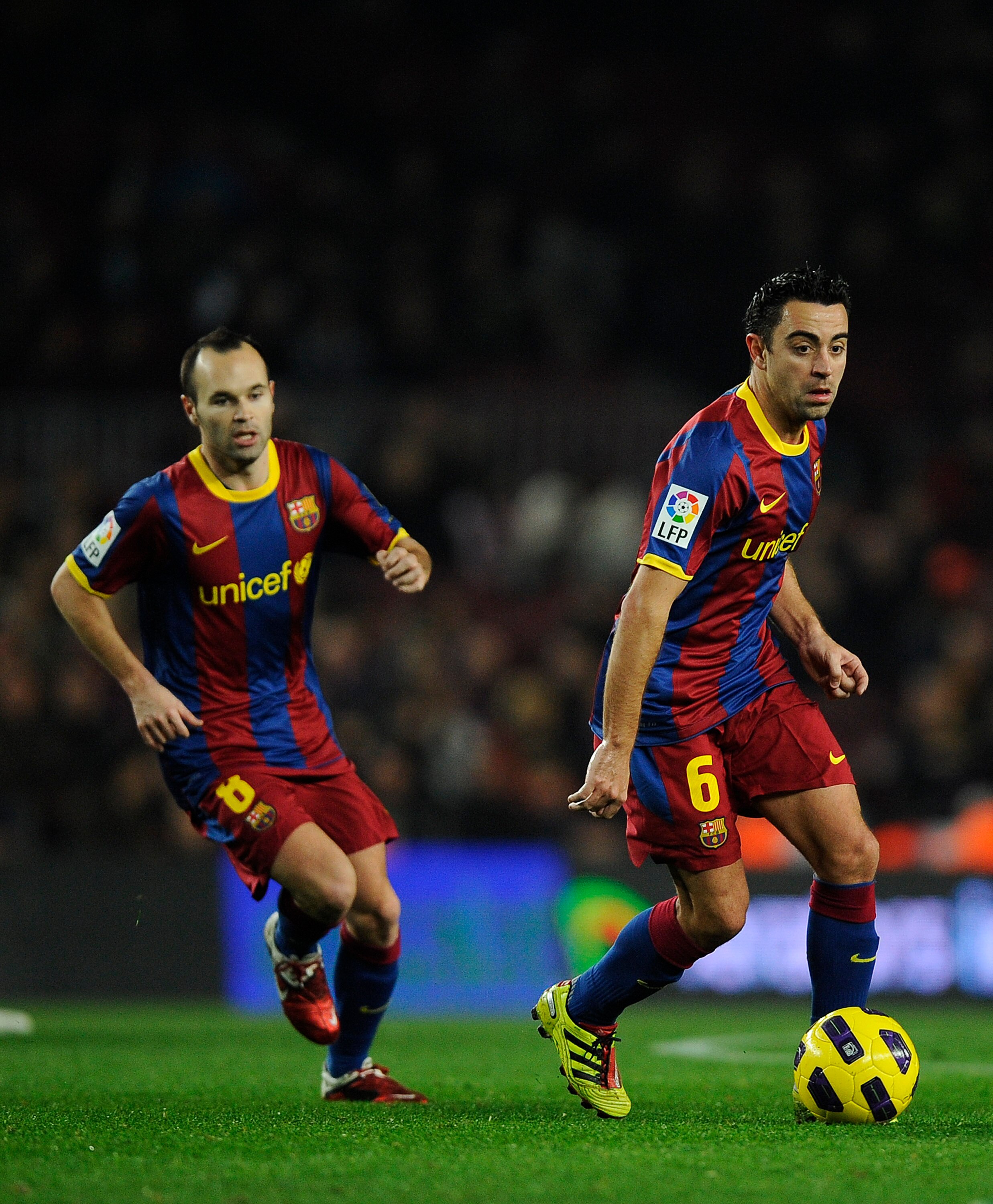 BARCELONA, SPAIN - JANUARY 12:  Xavi Hernandez of FC Barcelona (R) and his teammate Andres Iniesta in action during the Copa del Rey quarter final first leg match between FC Barcelona and Betis at Camp Nou on January 12, 2011 in Barcelona, Spain. Barcelon