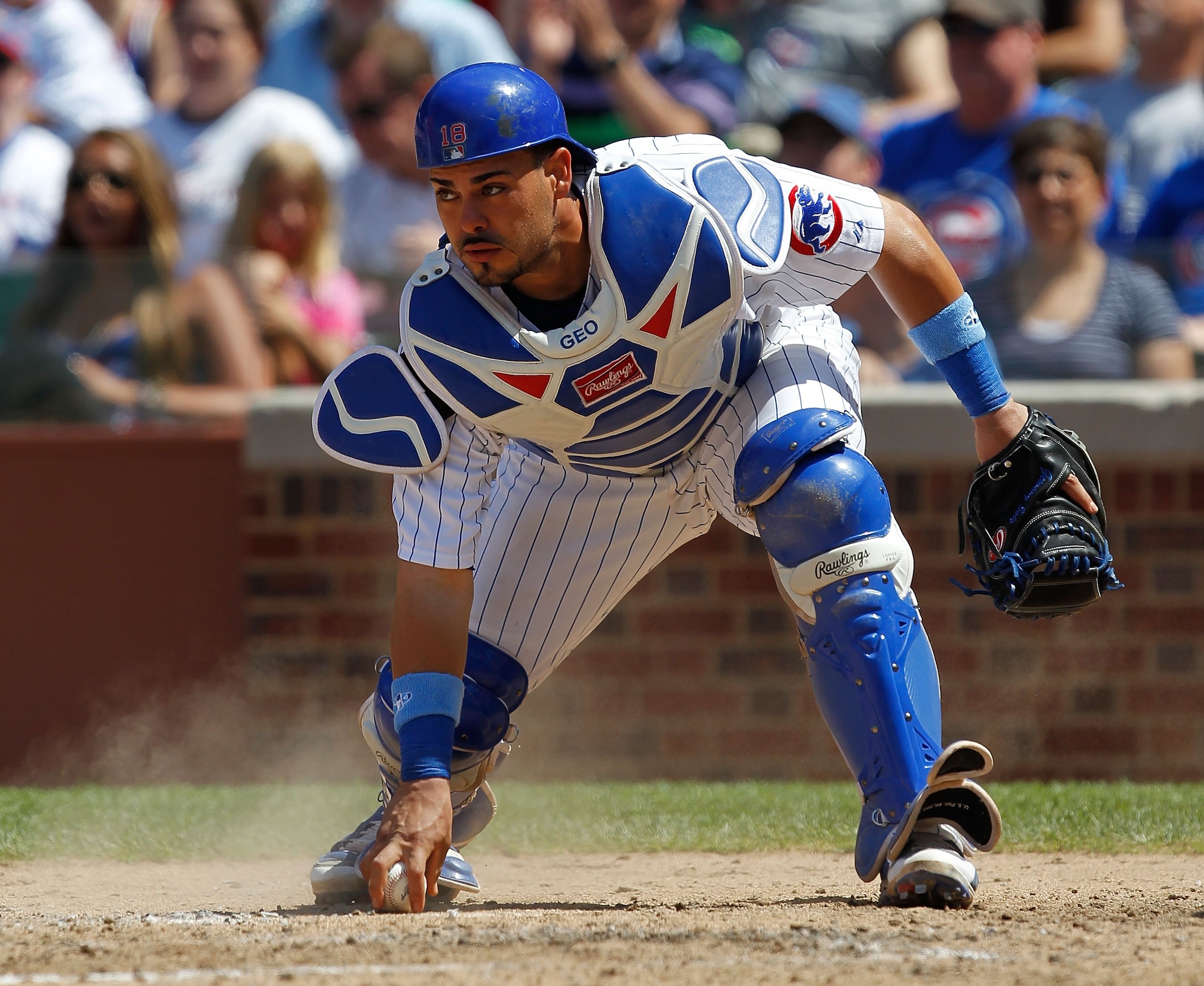 CHICAGO - JUNE 20: Geovany Soto #18 of the Chicago Cubs picks up the ball against the Los Angeles Angels of Anaheim at Wrigley Field on June 20, 2010 in Chicago, Illinois. The Cubs defeated the Angels 12-1. (Photo by Jonathan Daniel/Getty Images)