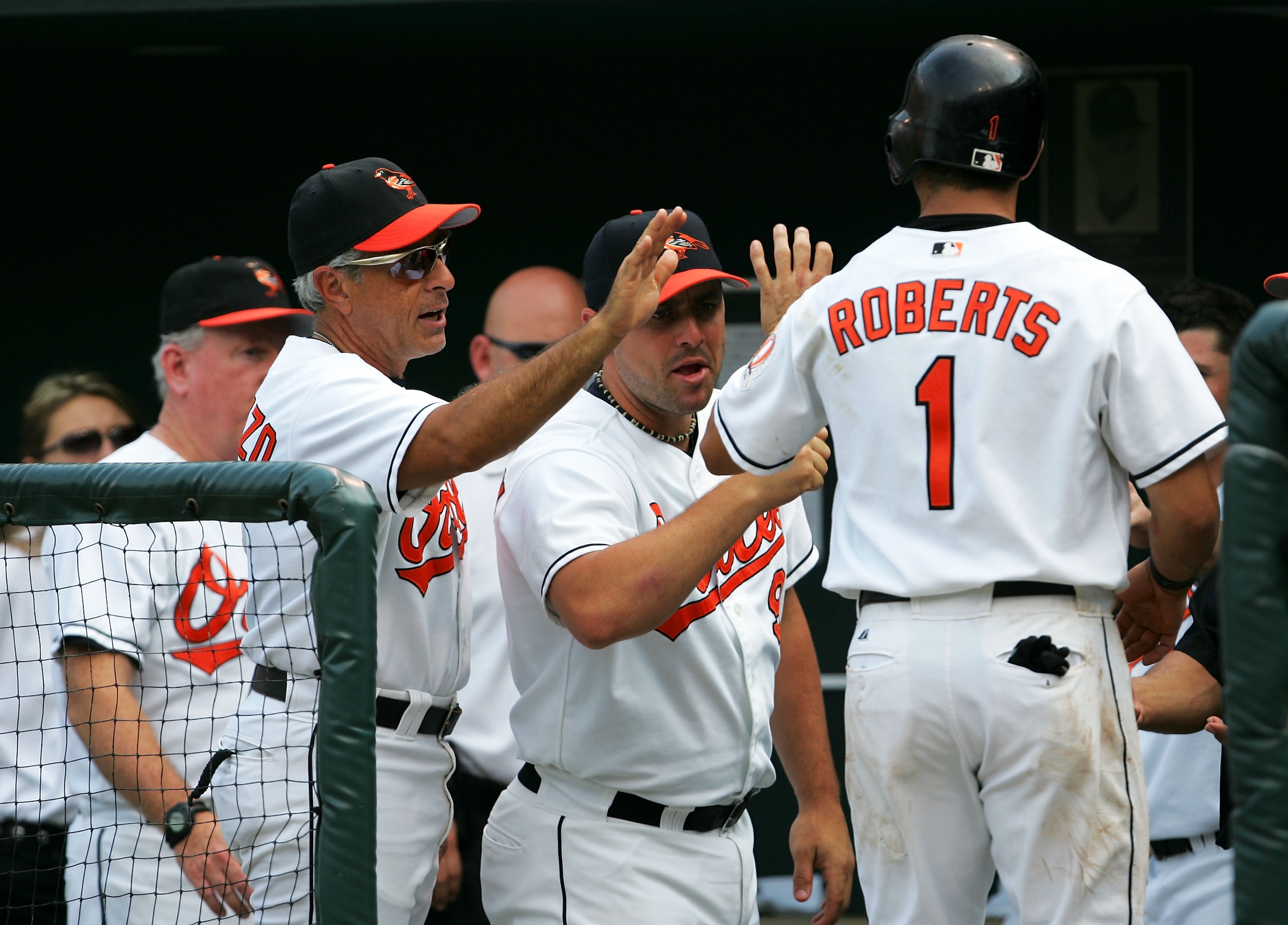 BALTIMORE - AUGUST 3: Brian Roberts #1 Baltimore Orioles is congratulated by teammates after scoring during the game against the Seattle Mariners at Camden Yards August 3, 2004 in Baltimore, Maryland. (Photo by Jamie Squire/Getty Images) BALTIMORE - AUGUST 3: Brian Roberts #1 Baltimore Orioles is congratulated by teammates after scoring during the game against the Seattle Mariners at Camden Yards August 3, 2004 in Baltimore, Maryland. (Photo by Jamie Squire/Getty Images)