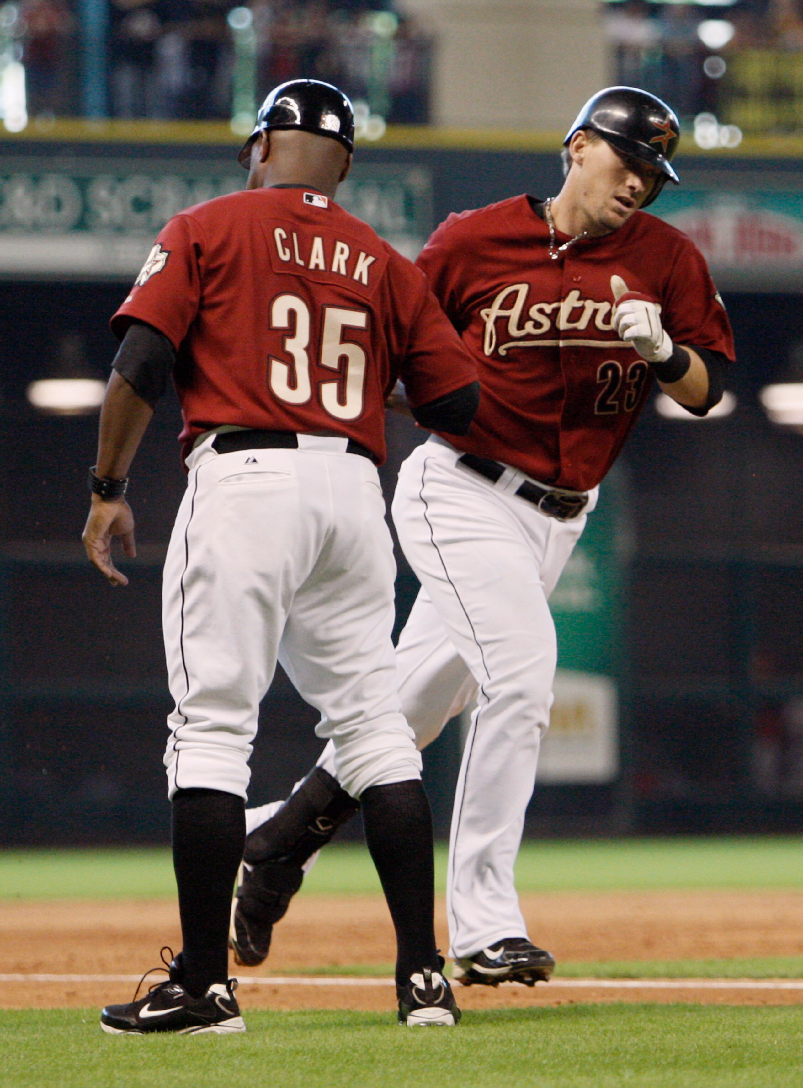 HOUSTON - JULY 25:  Chris Johnson #23 of the Houston Astros receives congratulations from third base coach Dave Clark #35 after hitting a home run in the seventh inning against the Cincinnati Reds at Minute Maid Park on July 25, 2010 in Houston, Texas.  (