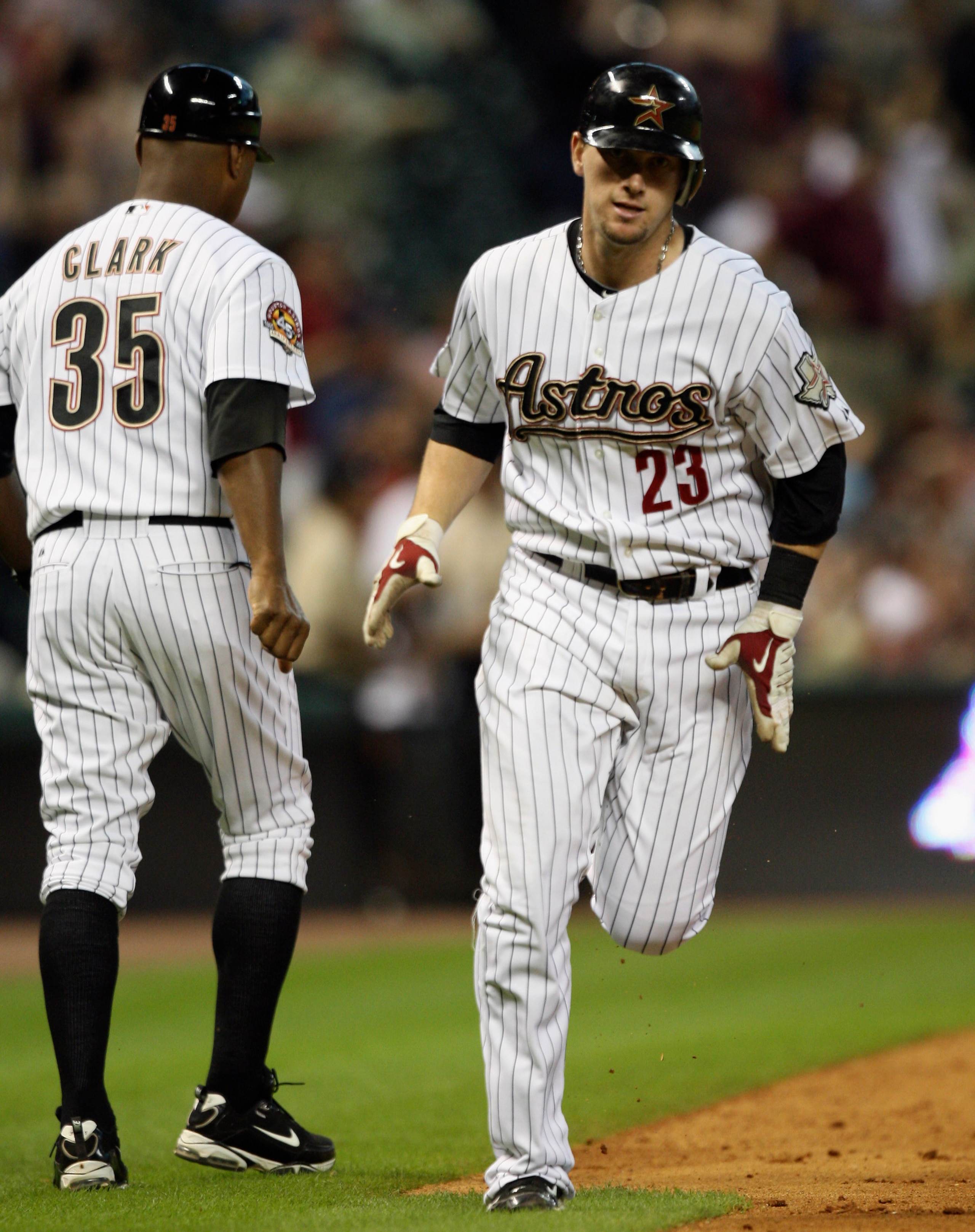 HOUSTON - JULY 30:  Chris Johnson #23 of the Houston Astros receives congratulations from third base coach Dave Clark #35 after hitting a home run in the fourth inning against the Milwaukee Brewers at Minute Maid Park on July 30, 2010 in Houston, Texas.