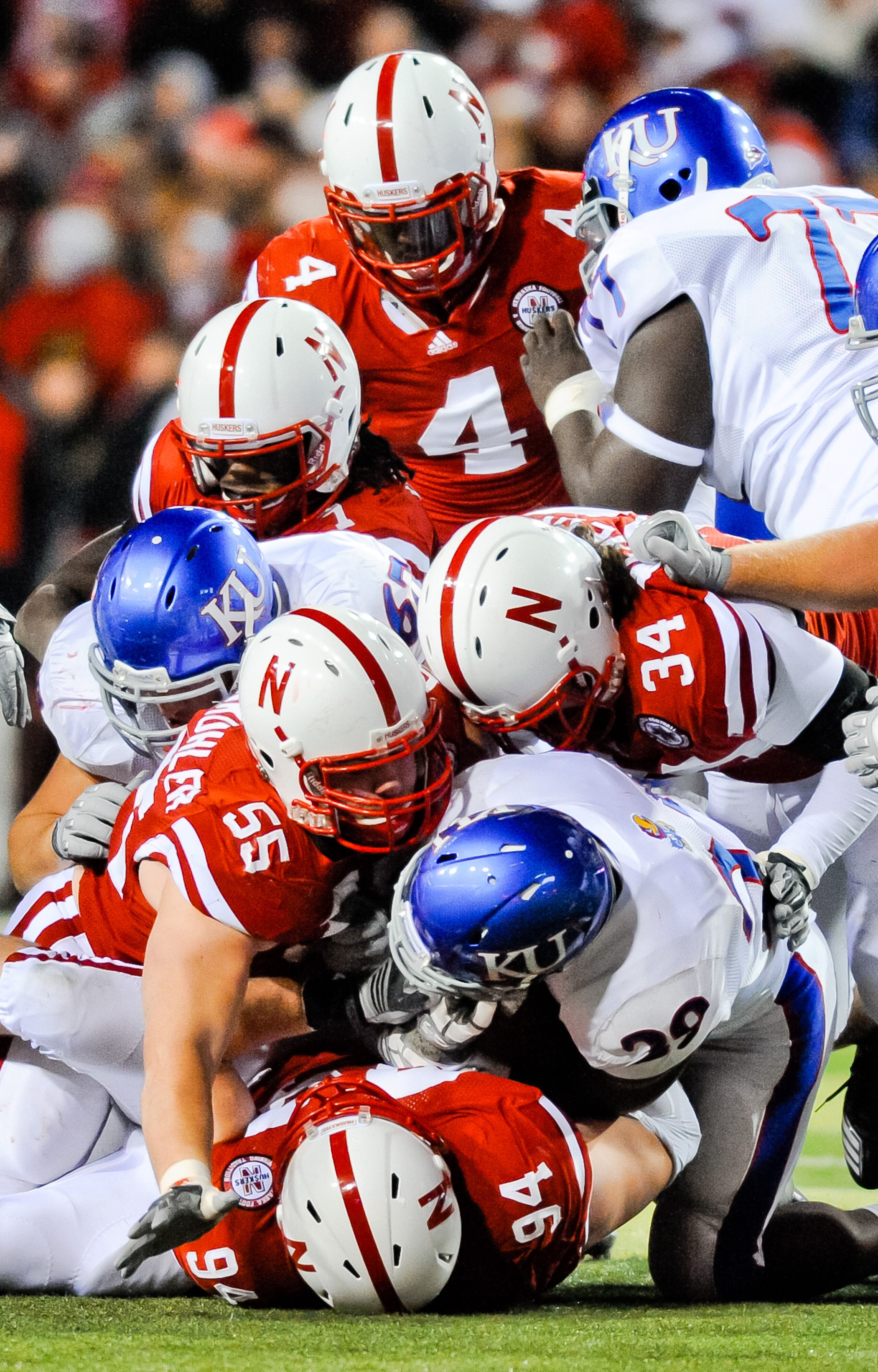 LINCOLN, NE - NOVEMBER 13: The Nebraska Cornhusker defense swarms James Sims #29 of the Kansas Jayhawks during their game at Memorial Stadium on November 13, 2010 in Lincoln, Nebraska. Nebraska Defeated Kansas 20-3. (Photo by Eric Francis/Getty Images)