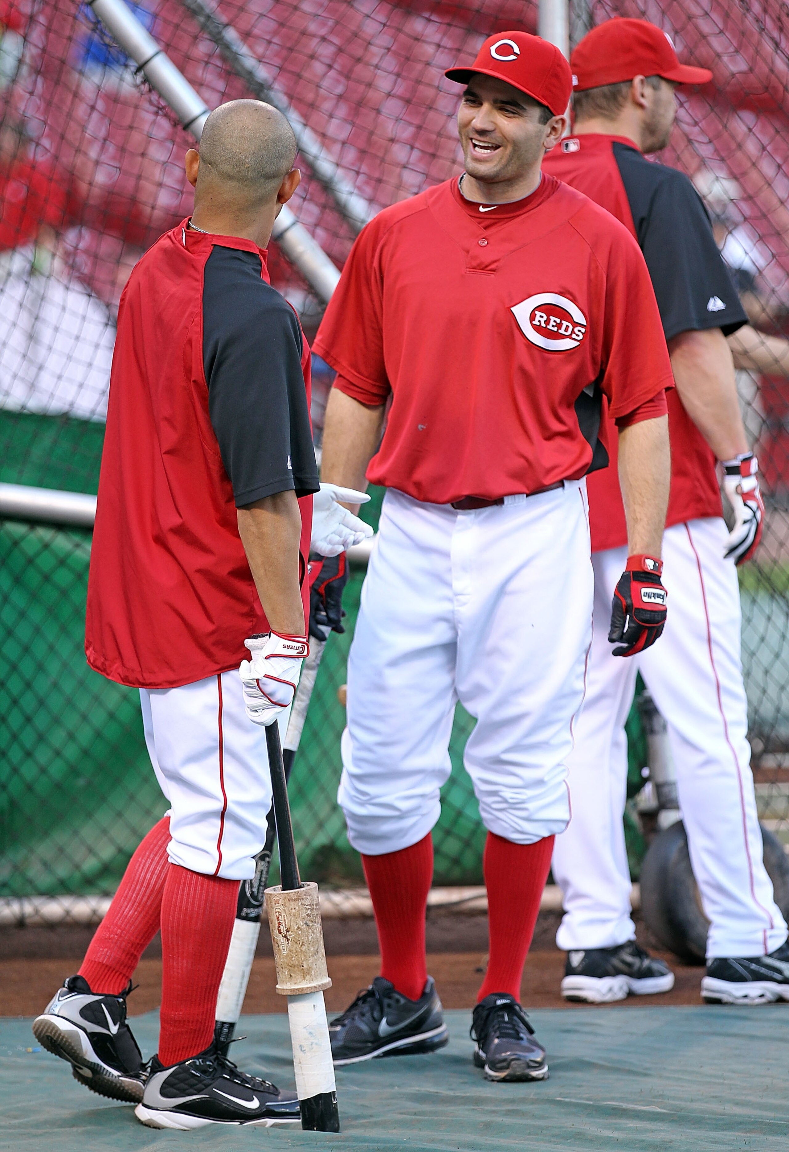 CINCINNATI - OCTOBER 10: Joey Votto #19 (right) of the Cincinnati Reds shares a laugh with Orlando Cabrera #2 in batting practice before the start of Game 3 of the NLDS against the Philadelphia Phillies at Great American Ball Park on October 10, 2010 i CINCINNATI - OCTOBER 10: Joey Votto #19 (right) of the Cincinnati Reds shares a laugh with Orlando Cabrera #2 in batting practice before the start of Game 3 of the NLDS against the Philadelphia Phillies at Great American Ball Park on October 10, 2010 i