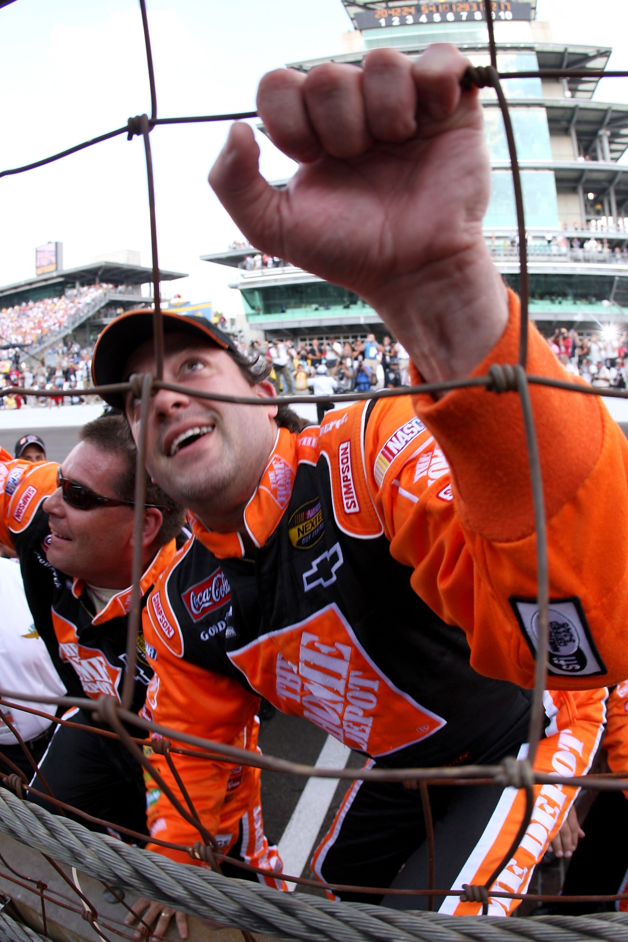 INDIANAPOLIS - JULY 29:  Tony Stewart, driver of the #20 Home Depot Chevrolet, climbs the fence after winning the NASCAR Nextel Cup Series 14th Allstate 400 at the Brickyard at Indianapolis Motor Speedway on July 29, 2007 in Indianapolis, Indiana.  (Photo