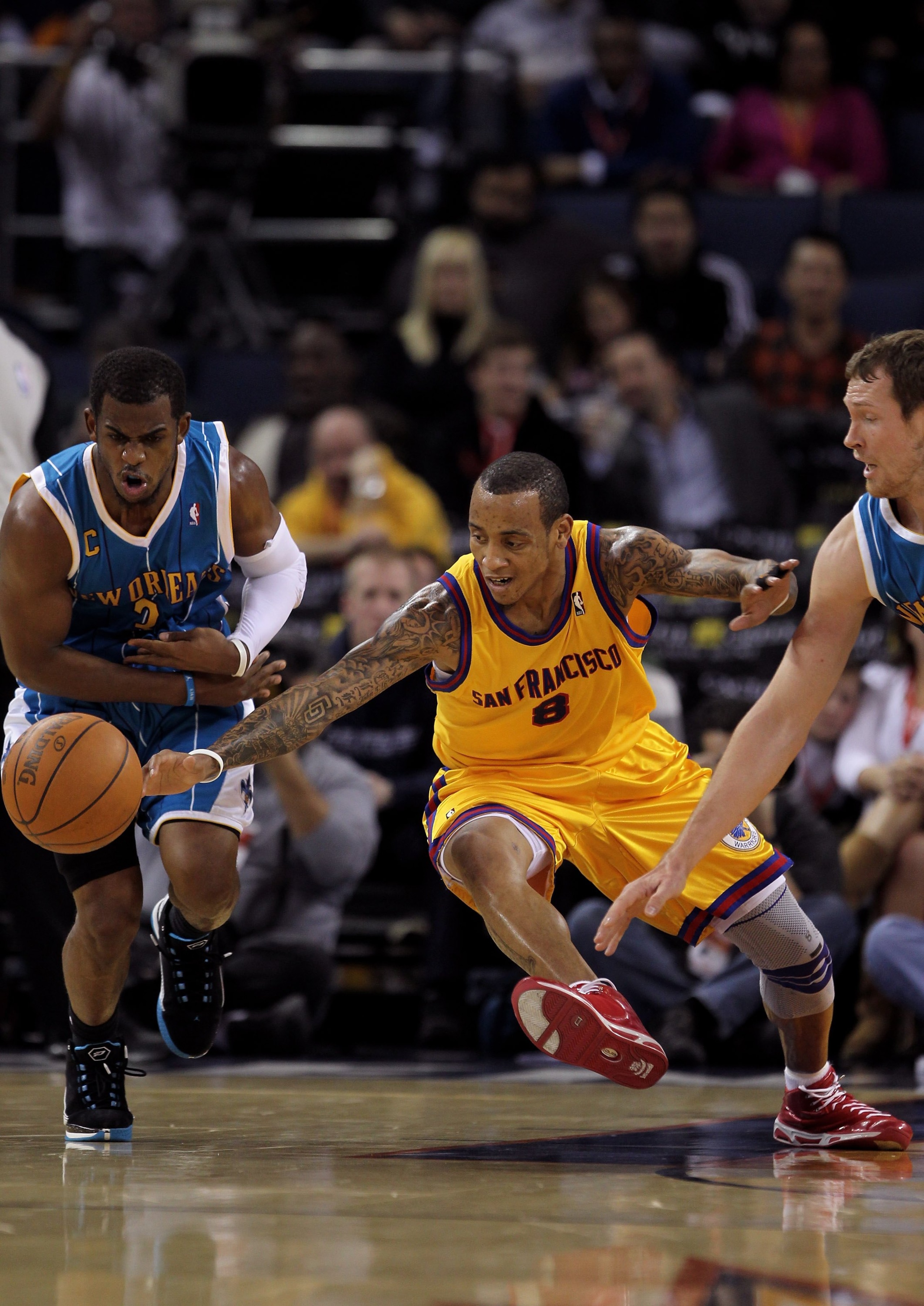 OAKLAND, CA - JANUARY 27:  Monta Ellis #8 of the Golden State Warriors and Chris Paul #3 of the New Orleans Hornets scramble for a loose ball at Oracle Arena on January 27, 2010 in Oakland, California.  NOTE TO USER: User expressly acknowledges and agrees