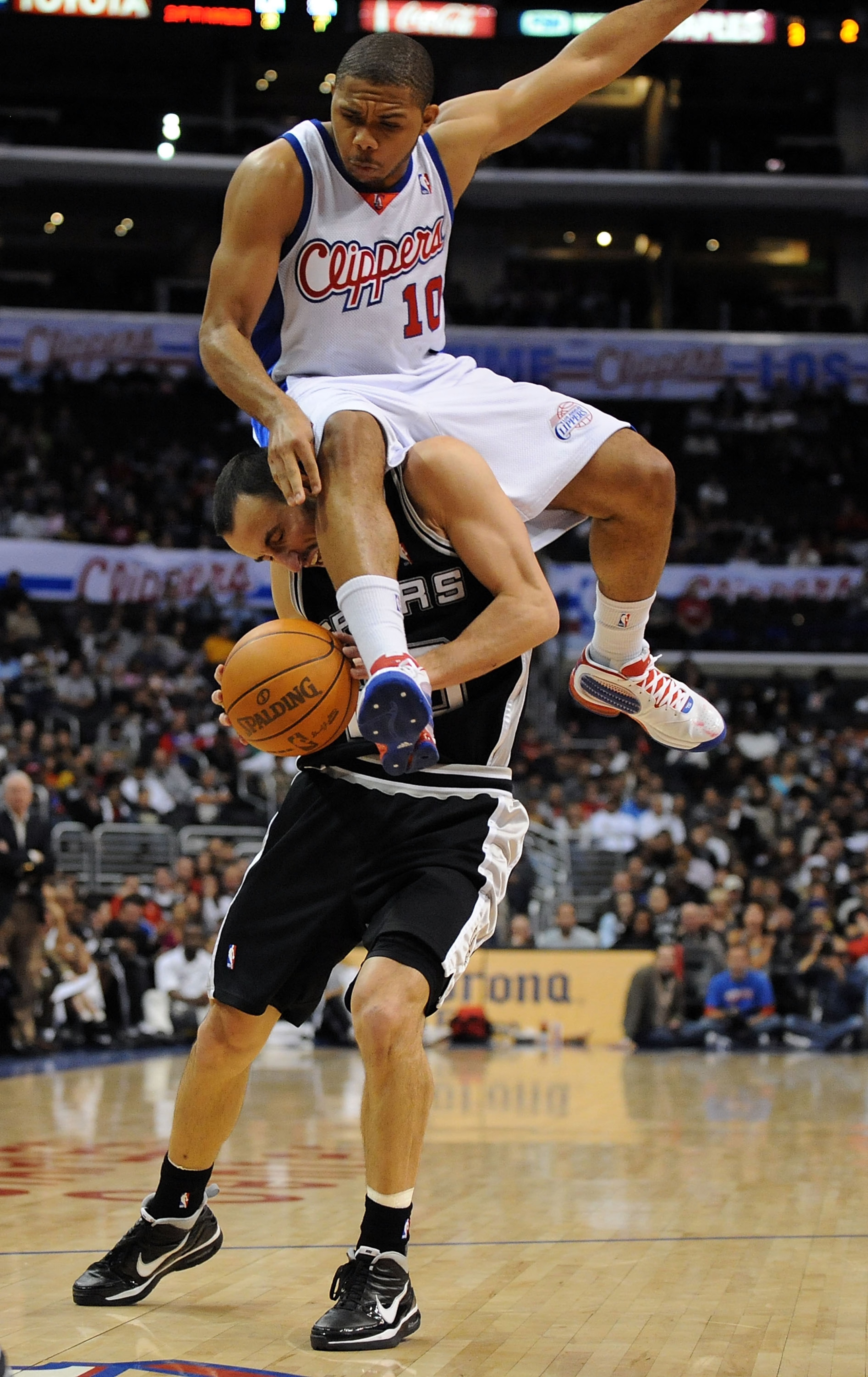 LOS ANGELES, CA - DECEMBER 13:  Eric Gordon #10 of the Los Angeles Clippers lands on Manu Ginobili #20 of the San Antonio Spurs attempting to block his shot during the game at Staples Center on December 13, 2009 in Los Angeles, California.  The Spurs won