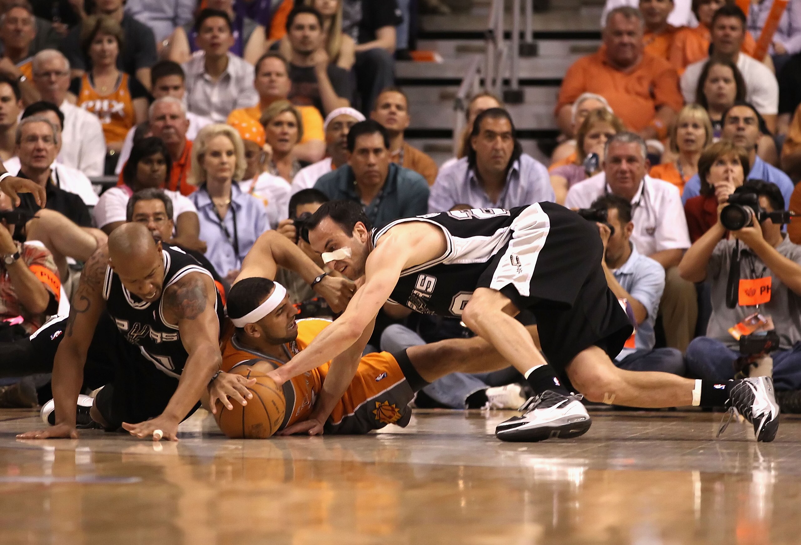 PHOENIX - MAY 05:  Manu Ginobili #20 and Keith Bogans #10 of the San Antonio Spurs battle for a loose ball with Jared Dudley #2 of the Phoenix Suns during Game Two of the Western Conference Semifinals of the 2010 NBA Playoffs at US Airways Center on May 5
