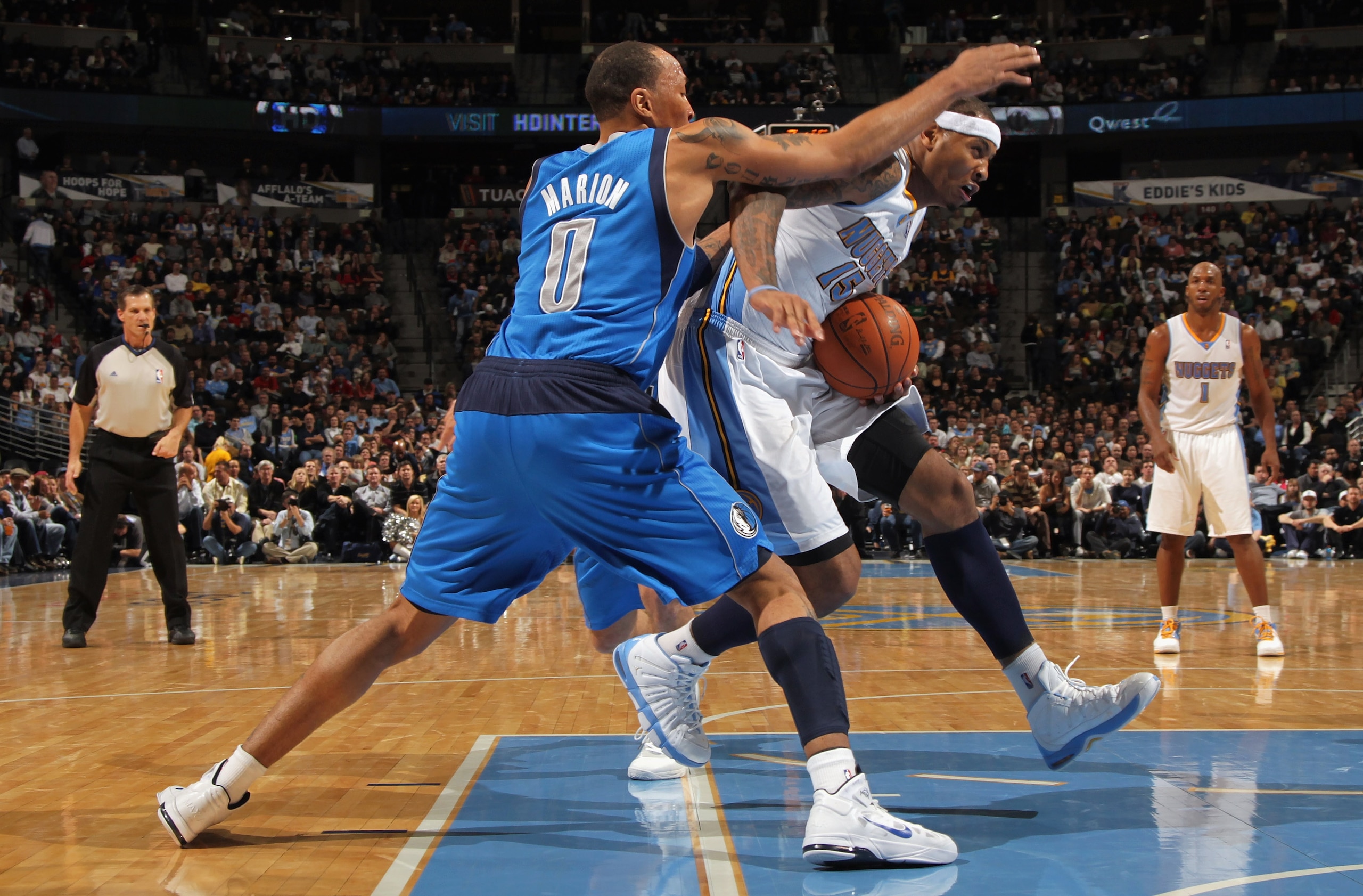 DENVER, CO - FEBRUARY 10:  Carmelo Anthony #15 of the Denver Nuggets drives to the basket against Shawn Marion #0 of the Dallas Mavericks during NBA action at the Pepsi Center on February 10, 2011 in Denver, Colorado. The Nuggets defeated the Mavericks 12