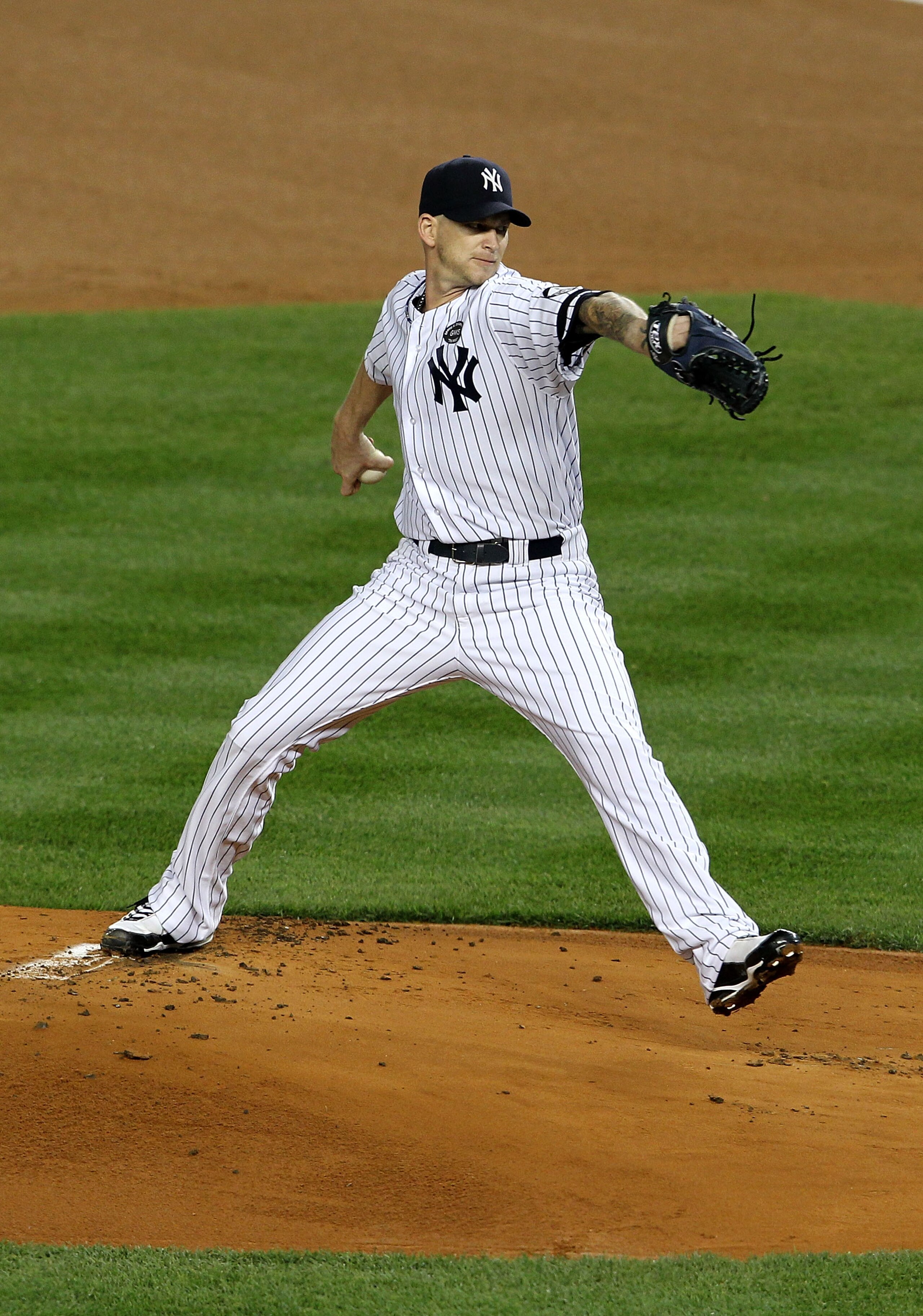 NEW YORK - OCTOBER 19: A.J. Burnett #34 of the New York Yankees pitches against the Texas Rangers in Game Four of the ALCS during the 2010 MLB Playoffs at Yankee Stadium on October 19, 2010 in the Bronx borough of New York City. The Rangers won 10-3. (P NEW YORK - OCTOBER 19: A.J. Burnett #34 of the New York Yankees pitches against the Texas Rangers in Game Four of the ALCS during the 2010 MLB Playoffs at Yankee Stadium on October 19, 2010 in the Bronx borough of New York City. The Rangers won 10-3. (P