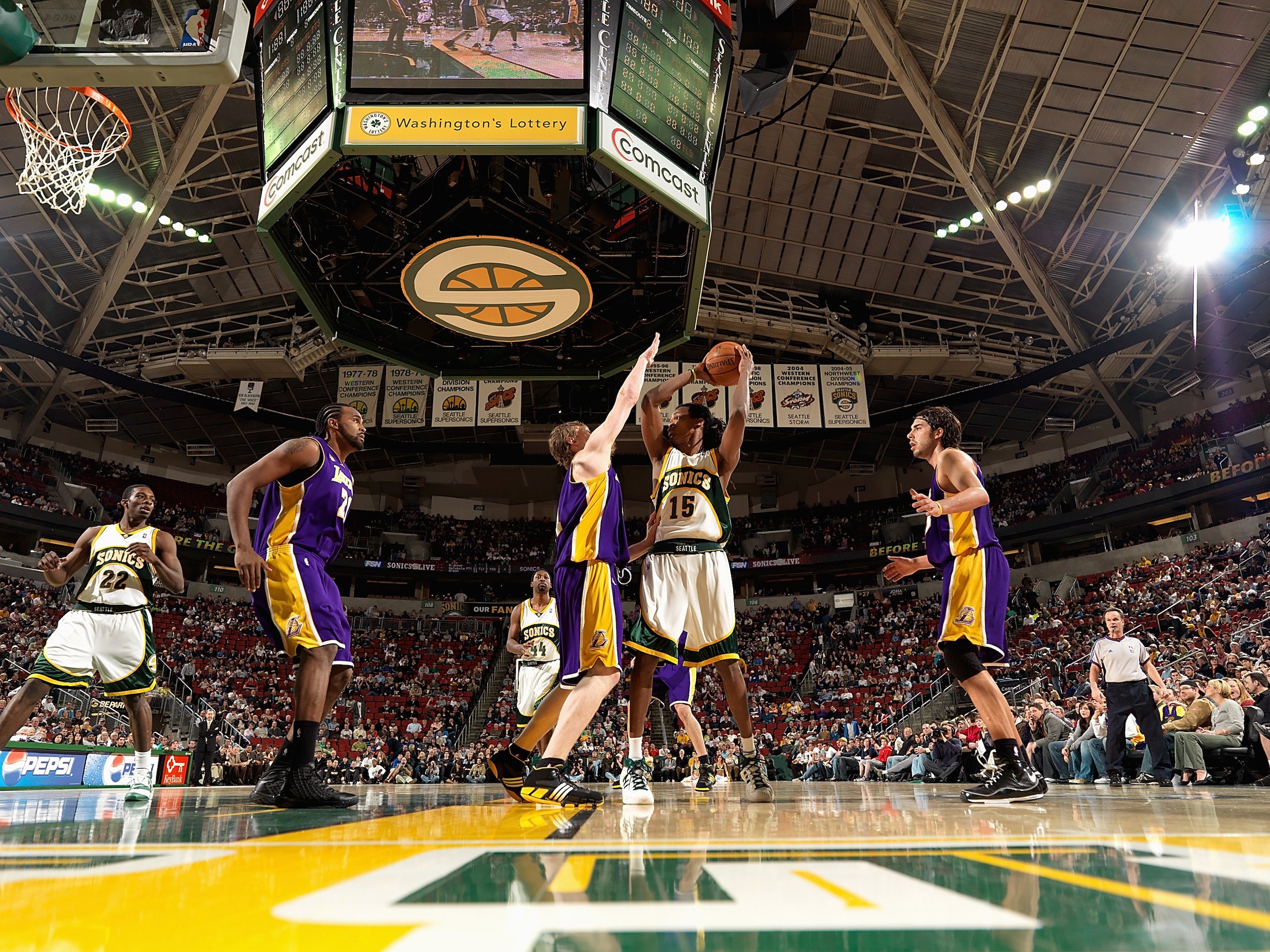 SEATTLE - FEBRUARY 24:  Mickael Gelabale #15 of the Seattle SuperSonics looks to pass over Coby Karl #11 of the Los Angeles Lakers during the game on February 24, 2008 at Key Arena in Seattle, Washington.  The Lakers won 111-91.  NOTE TO USER: User expres
