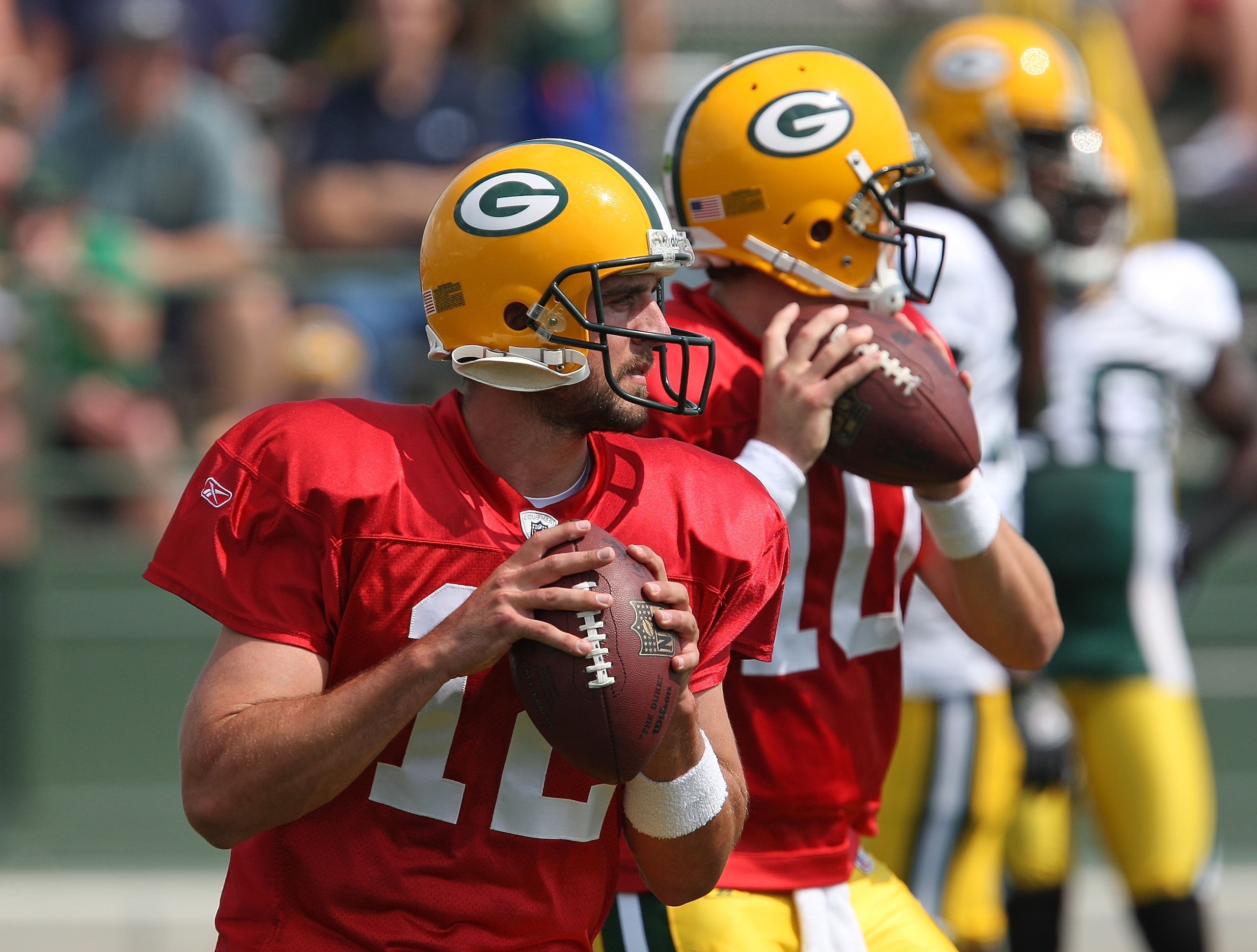GREEN BAY, WI - AUGUST 03: Aaron Rodgers #12 and Matt Flynn #10 of the Green Bay Packers drop back to pass during practice at summer training camp on August 3, 2009 at the Ray Nitschke Field in Green Bay, Wisconsin. (Photo by Jonathan Daniel/Getty Images)