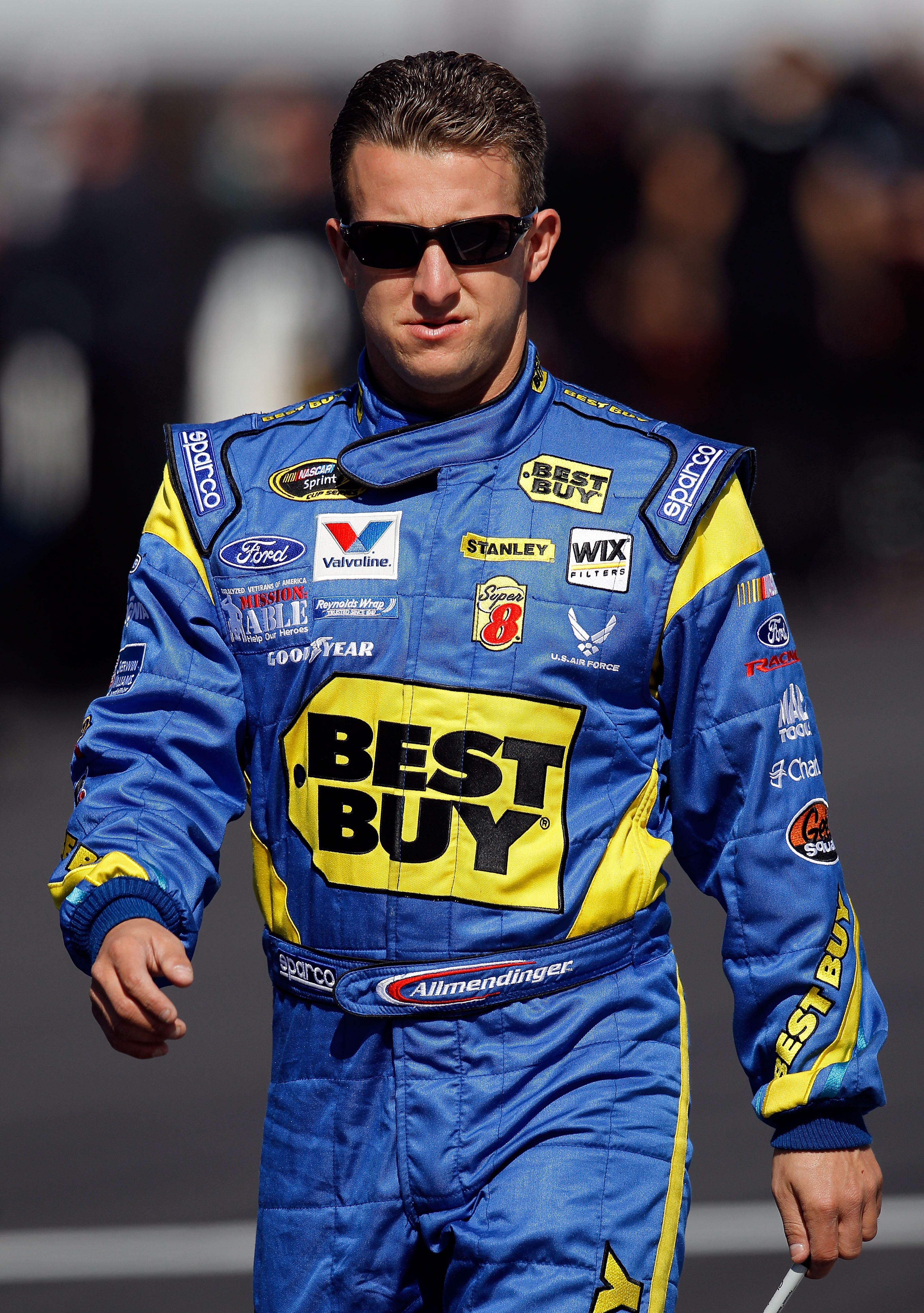 DAYTONA BEACH, FL - FEBRUARY 13:  A.J. Allmendinger, driver of the #43 Best Buy Ford, walks on the grid during qualifying for the NASCAR Sprint Cup Series Daytona 500 at Daytona International Speedway on February 13, 2011 in Daytona Beach, Florida.  (Phot