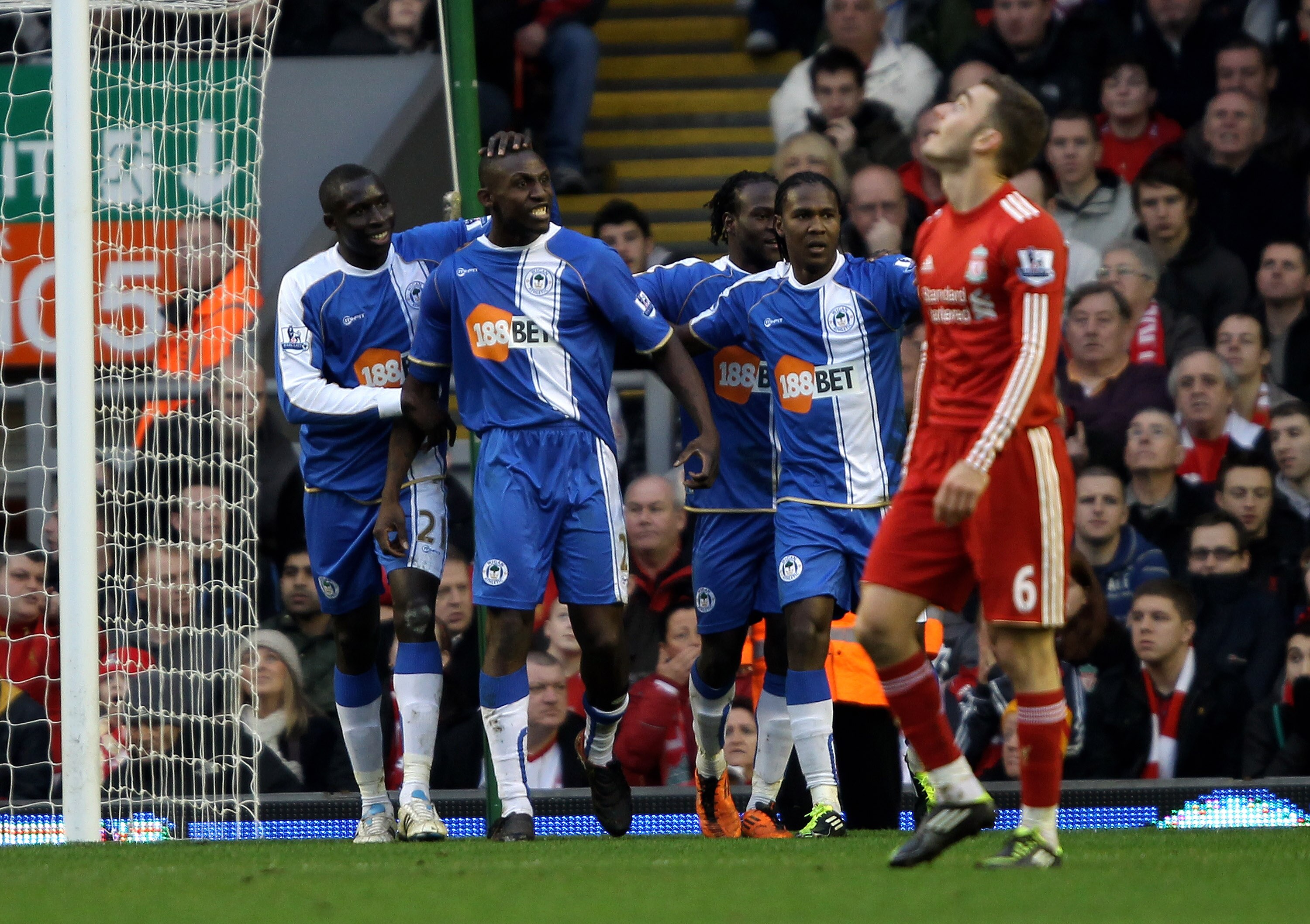 LIVERPOOL, ENGLAND - FEBRUARY 12:  Steve Gohouri of Wigan Athletic celebrates scoring his team's first goal with his team mates during the Barclays Premier League match between Liverpool and Wigan Athletic at Anfield on February 12, 2011 in Liverpool, Eng
