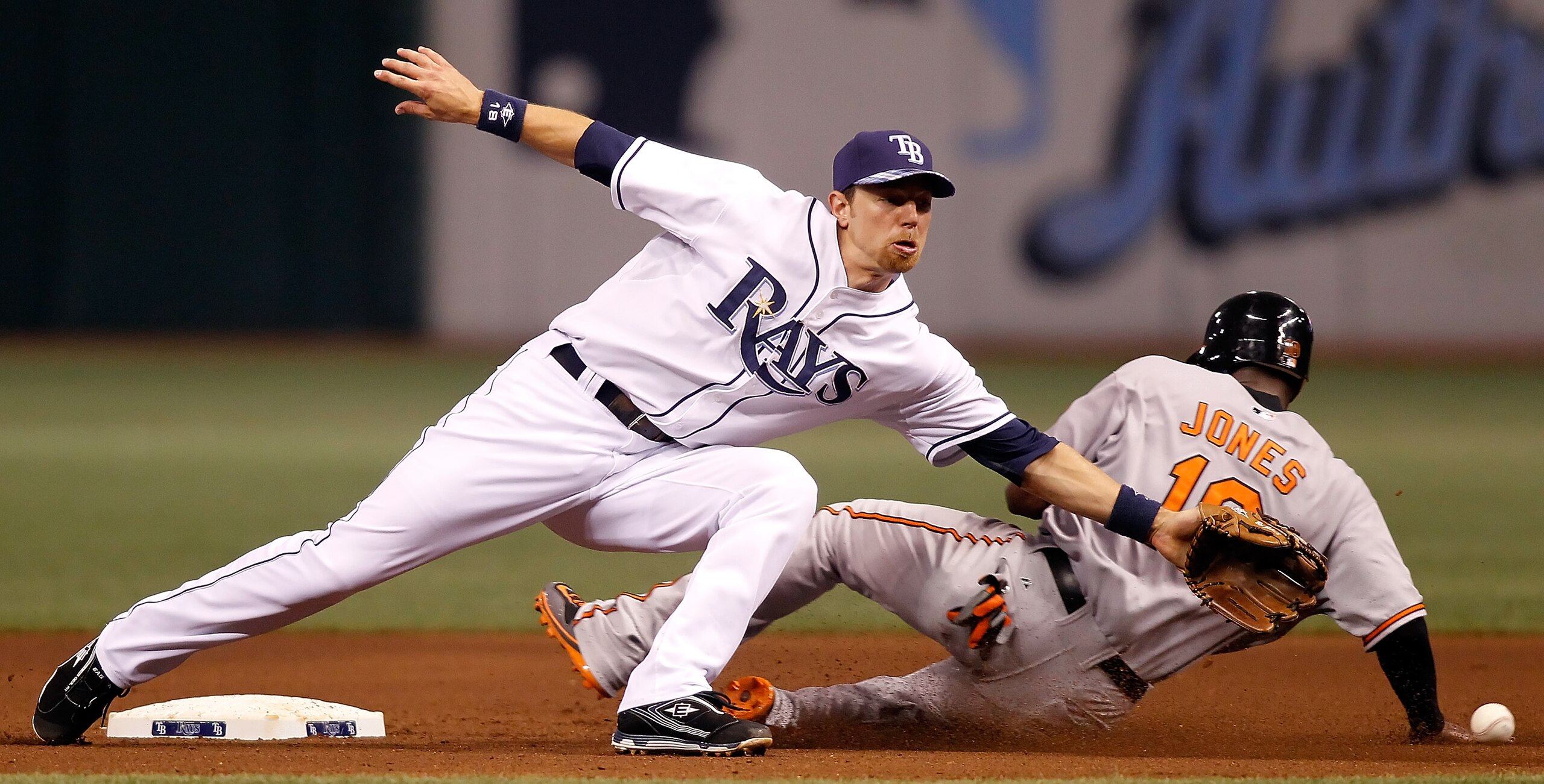 ST. PETERSBURG, FL - SEPTEMBER 29: Infielder Ben Zobrist #18 of the Tampa Bay Rays stretches for the throw as Adam Jones #10 of the Baltimore Orioles slides safely into second during the game at Tropicana Field on September 29, 2010 in St. Petersburg, Fl ST. PETERSBURG, FL - SEPTEMBER 29: Infielder Ben Zobrist #18 of the Tampa Bay Rays stretches for the throw as Adam Jones #10 of the Baltimore Orioles slides safely into second during the game at Tropicana Field on September 29, 2010 in St. Petersburg, Fl