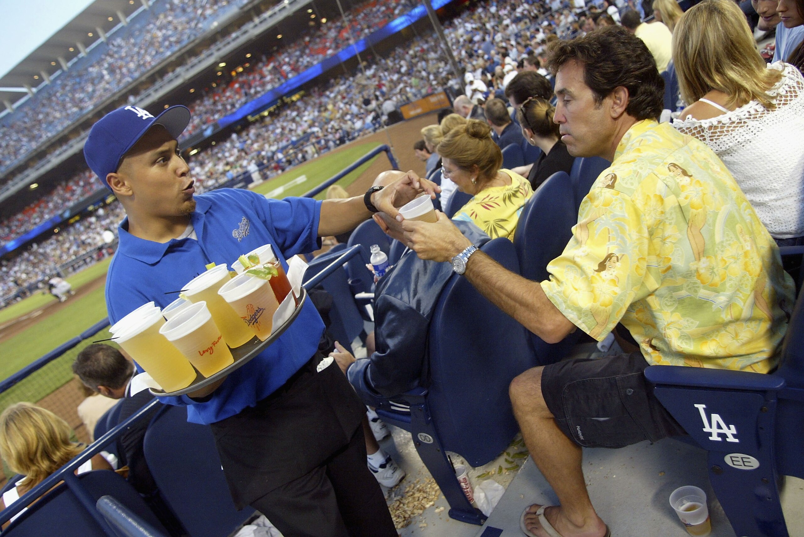 LOS ANGELES, CA - JULY 26: (U.S. TABS AND HOLLYWWOD REPORTER OUT)  Dodger fan Pat Theodora buys a beer in 'The Dugout Club' at Dodger Stadium on July 26, 2005 in Los Angeles California. (Photo by Matthew Simmons/Getty Images)