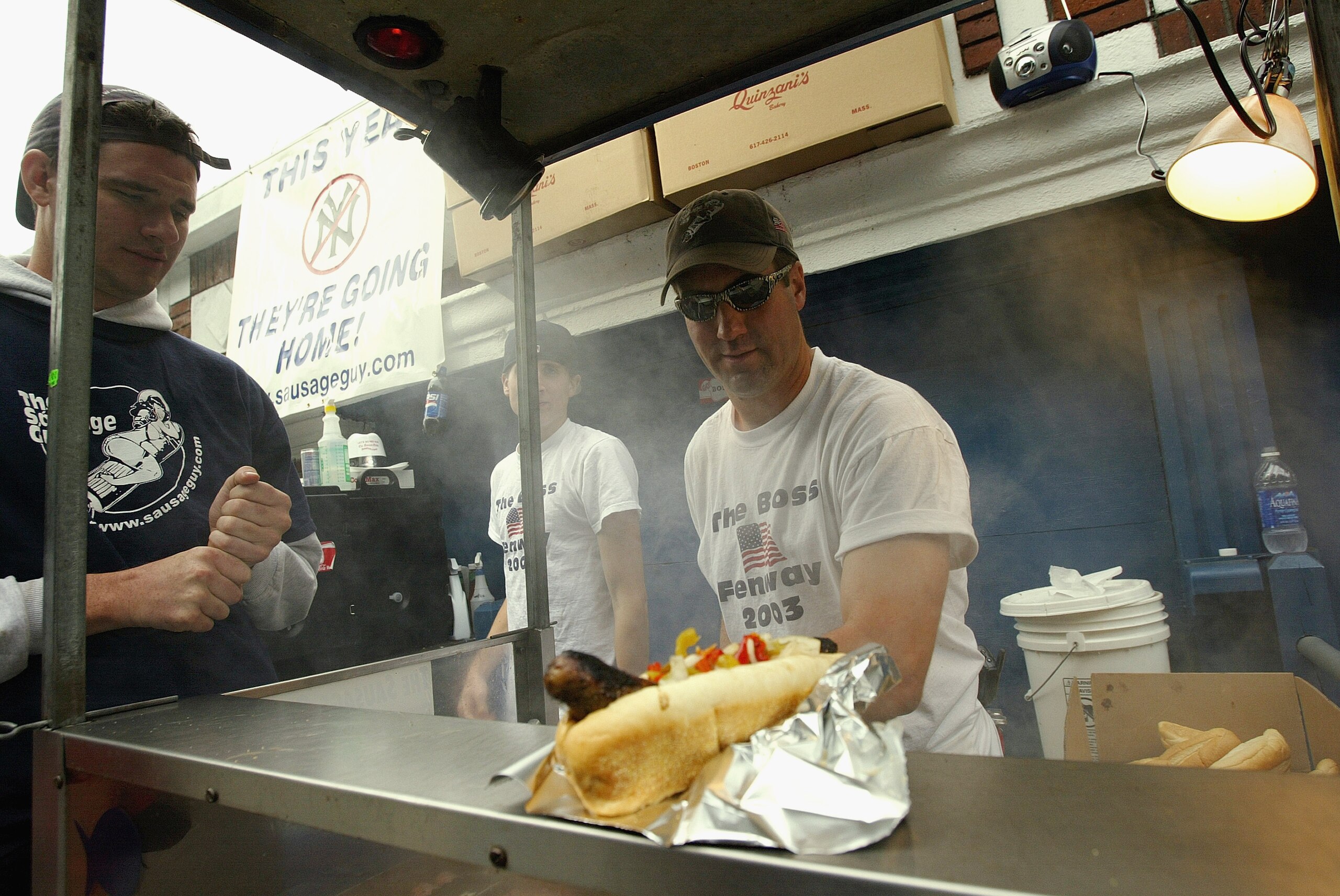 BOSTON - OCTOBER 14:  Food vendor prepares and serves hot dogs during Game five of the 2003 American League Championship Series between the Boston Red Sox and the New York Yankees at Fenway Park on October 14, 2003 in Boston, Massachusetts. The Yankees de