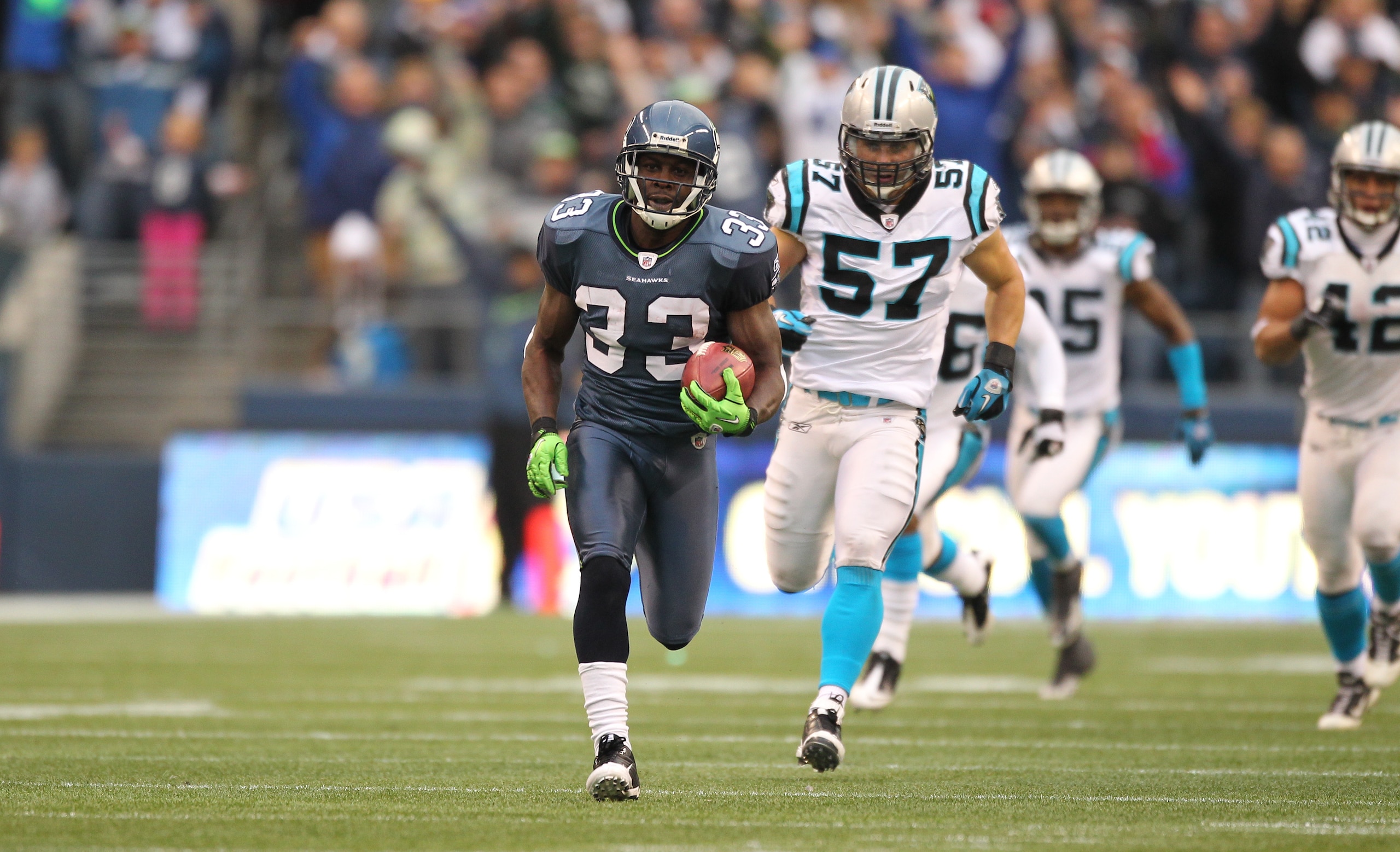 SEATTLE - DECEMBER 05:  Running back Leon Washington #33 of the Seattle Seahawks returns a punt for 84 yards against the Carolina Panthers at Qwest Field on December 5, 2010 in Seattle, Washington. Washington was down at the 2 yard line on the play, and t