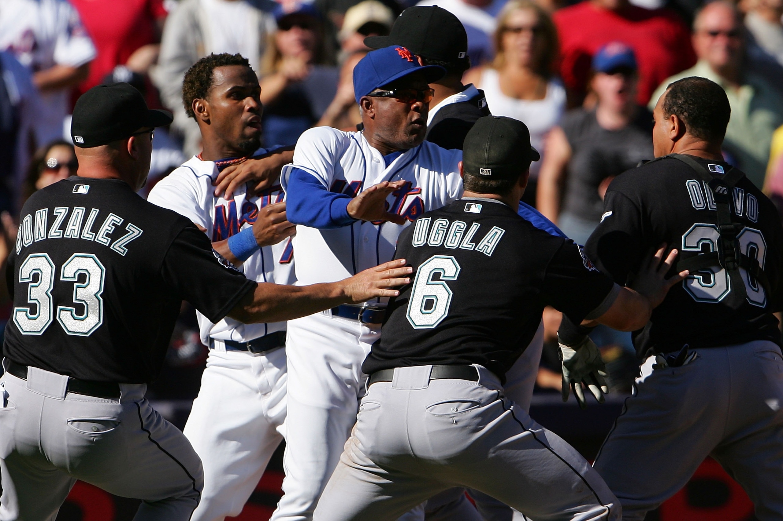 NEW YORK - SEPTEMBER 29:  Miguel Cabrera #24 of the Florida Marlins holds back Jose Reyes #7 of the New York Mets as New York Mets third base coach Sandy Alomar #28 holds back Marlins players Fredi Gonzalez #33, Dan Uggla #6 and Miguel Olivo #30 after a f