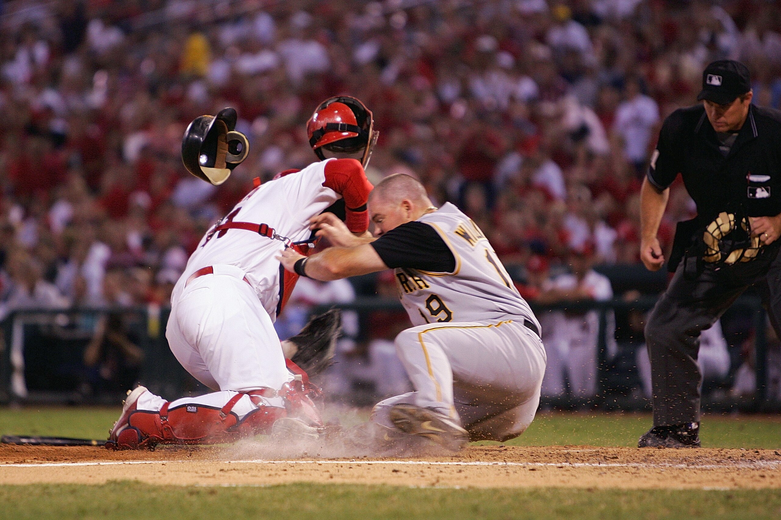 ST. LOUIS - SEPTEMBER 12:  Ty Wigginton #19 of the Pittsburgh Pirates collides with catcher Yadier Molina #41 of the St. Louis Cardinals at home plate during a game at Busch Stadium on September 12, 2005 in St. Louis, Missouri.  The Cardinals won 4-3.  (P