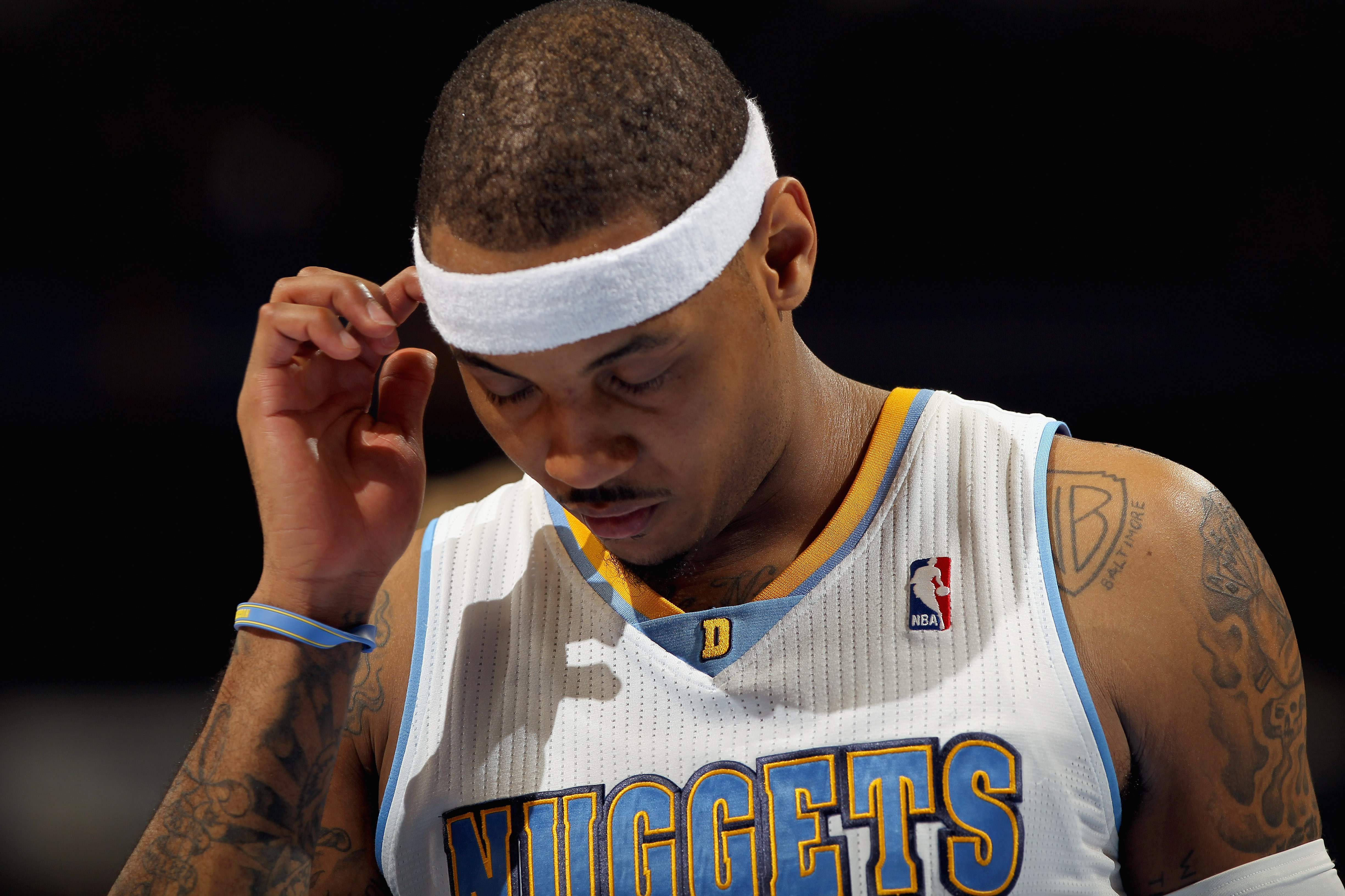 DENVER, CO - FEBRUARY 10:  Carmelo Anthony #15 of the Denver Nuggets looks on during a break in the action against the Dallas Mavericks during NBA action at the Pepsi Center on February 10, 2011 in Denver, Colorado. The Nuggets defeated the Mavericks 121-