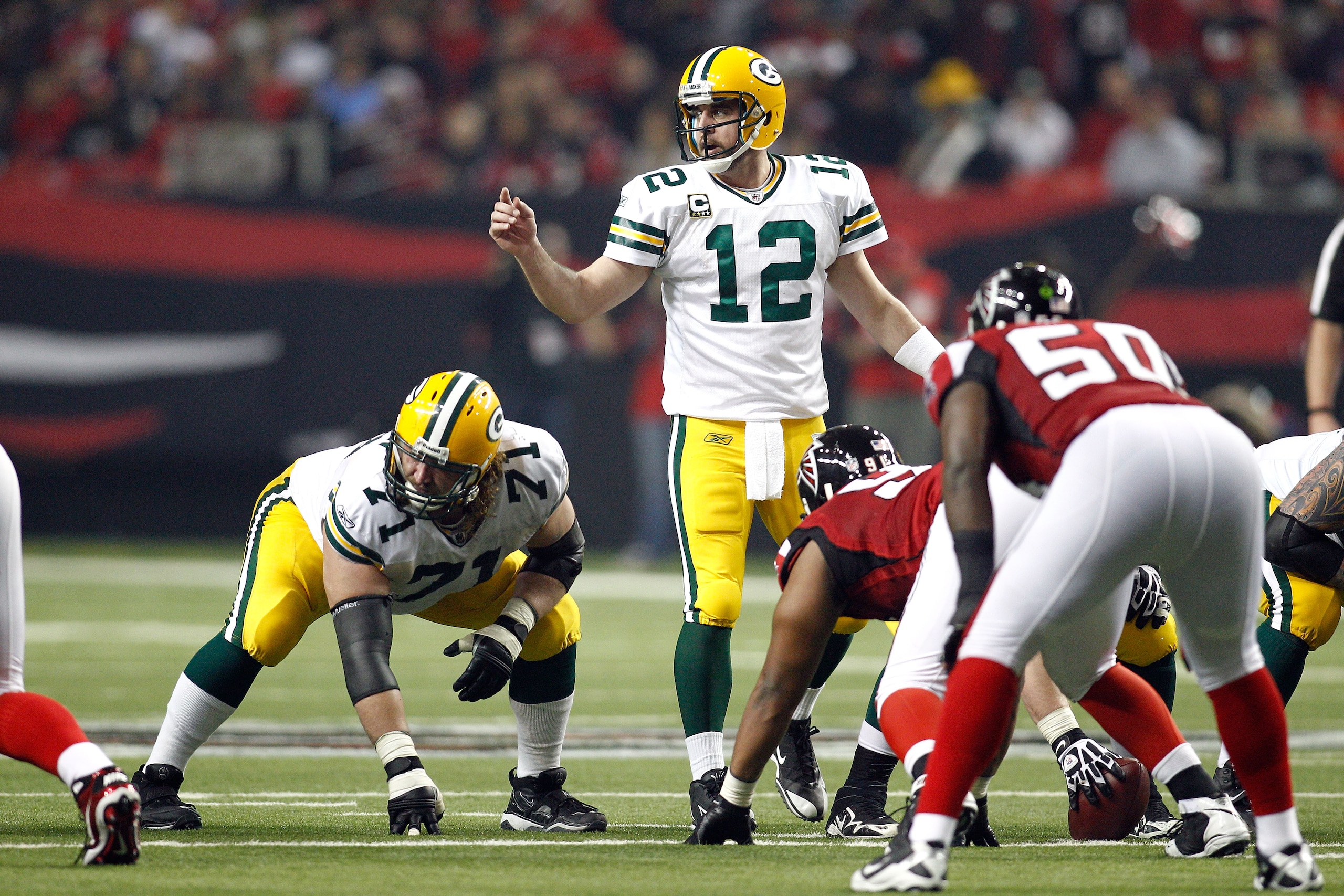 ATLANTA, GA - JANUARY 15:  Quarterback Aaron Rodgers #12 of the Green Bay Packers calls signals at the line of scrimmage next to guard Josh Sitton #71 against the Atlanta Falcons during their 2011 NFC divisional playoff game at Georgia Dome on January 15,