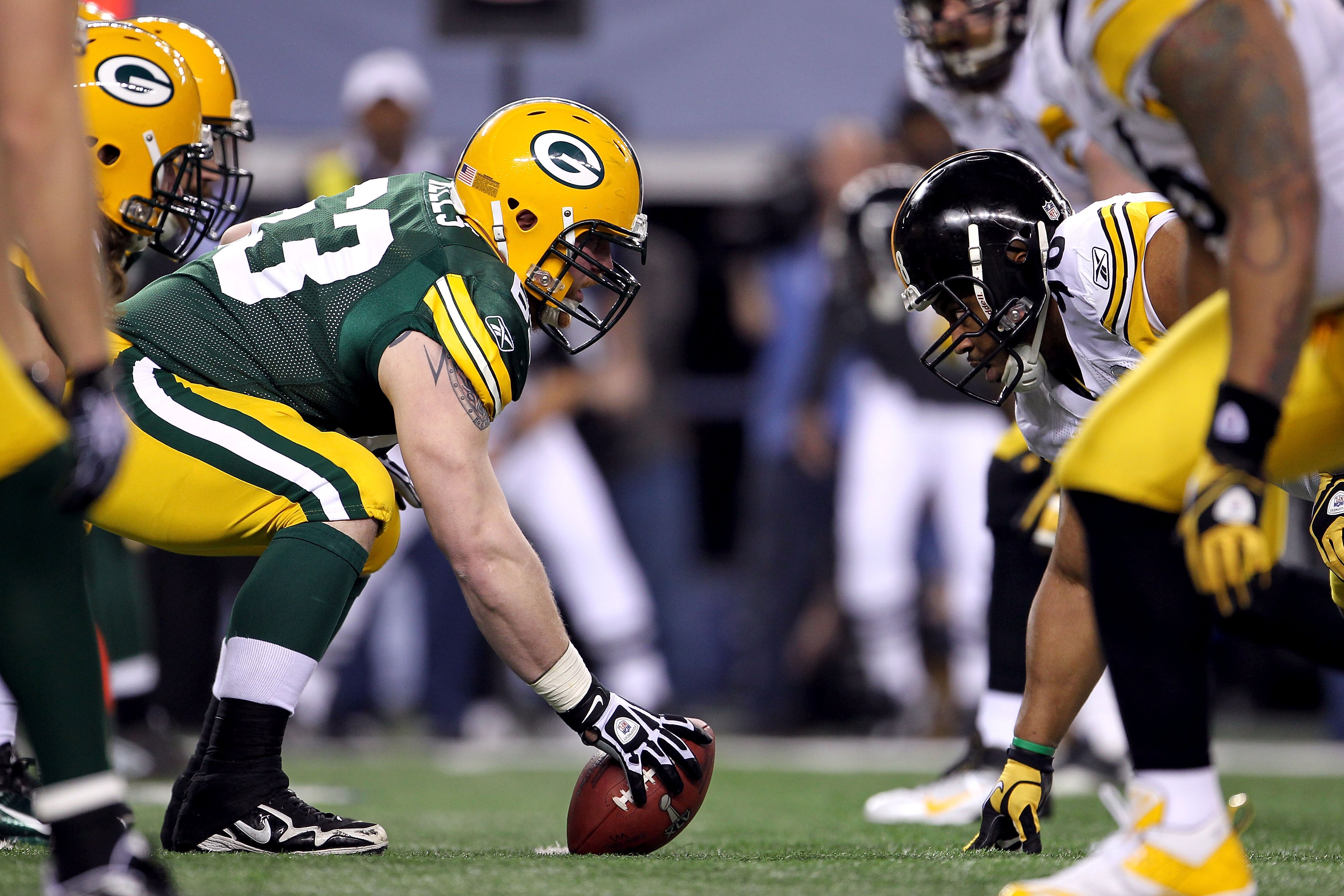 ARLINGTON, TX - FEBRUARY 06:  Center Scott Wells #63 of the Green Bay Packers gets set to snap the ball against Casey Hampton #98 of the Pittsburgh Steelers during Super Bowl XLV at Cowboys Stadium on February 6, 2011 in Arlington, Texas. The Packers won