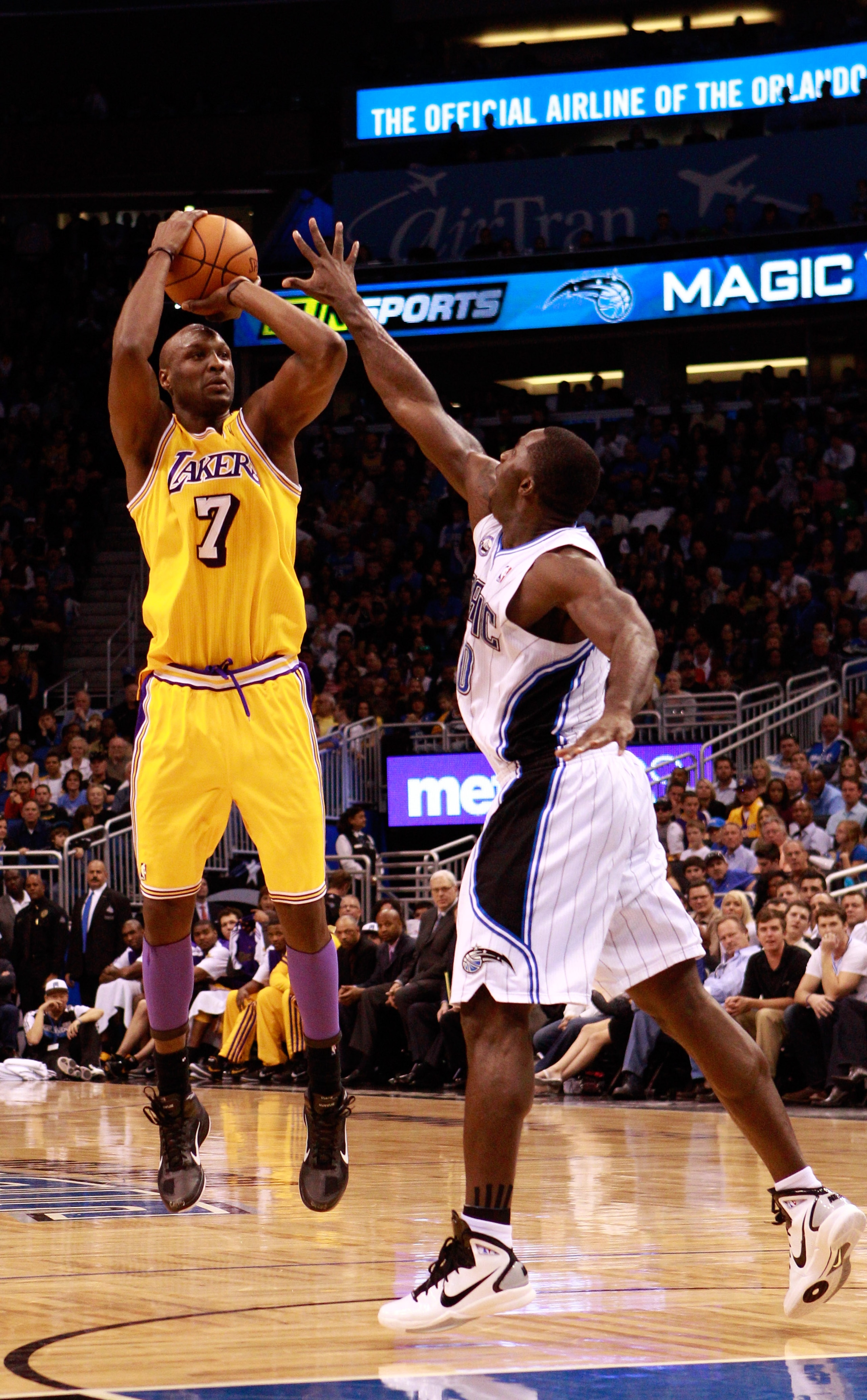 ORLANDO, FL - FEBRUARY 13:   Lamar Odom #7 of the Los Angeles Lakers attempts a shot over Brandon Bass #30 of the Orlando Magic during the game at Amway Arena on February 13, 2011 in Orlando, Florida.  NOTE TO USER: User expressly acknowledges and agrees