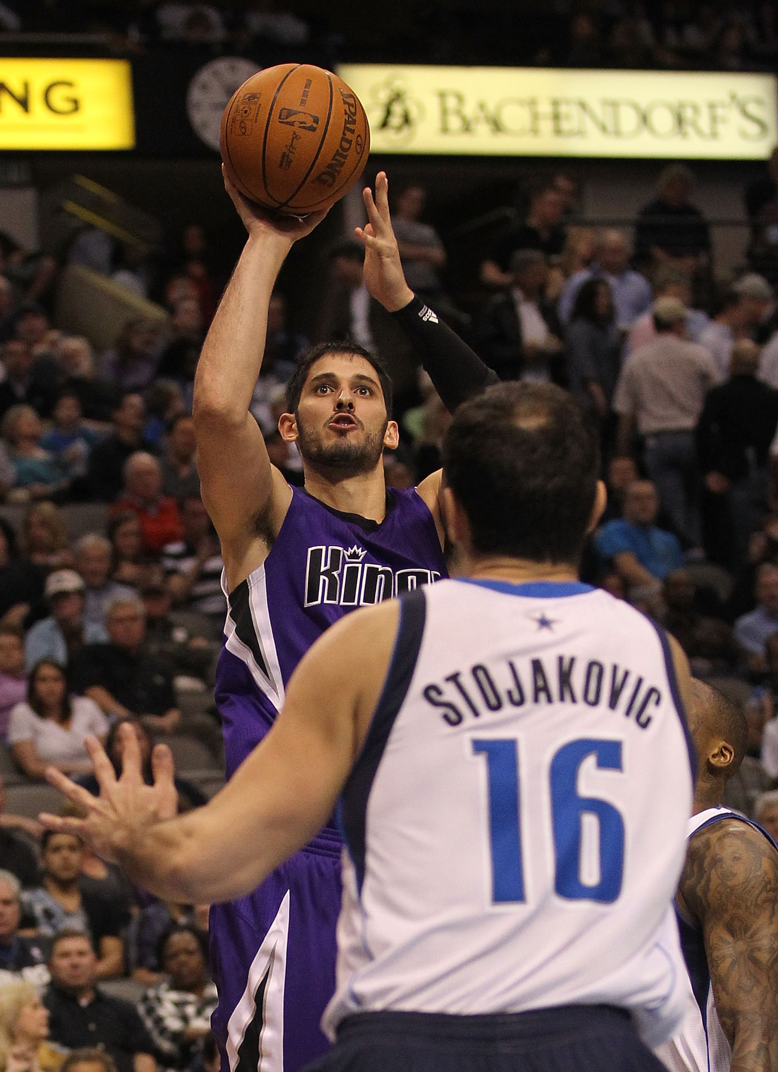 DALLAS, TX - FEBRUARY 16:  Forward Omri Casspi #18 of the Sacramento Kings takes a shot against Peja Stojakovic #16 of the Dallas Mavericks at American Airlines Center on February 16, 2011 in Dallas, Texas.  NOTE TO USER: User expressly acknowledges and a