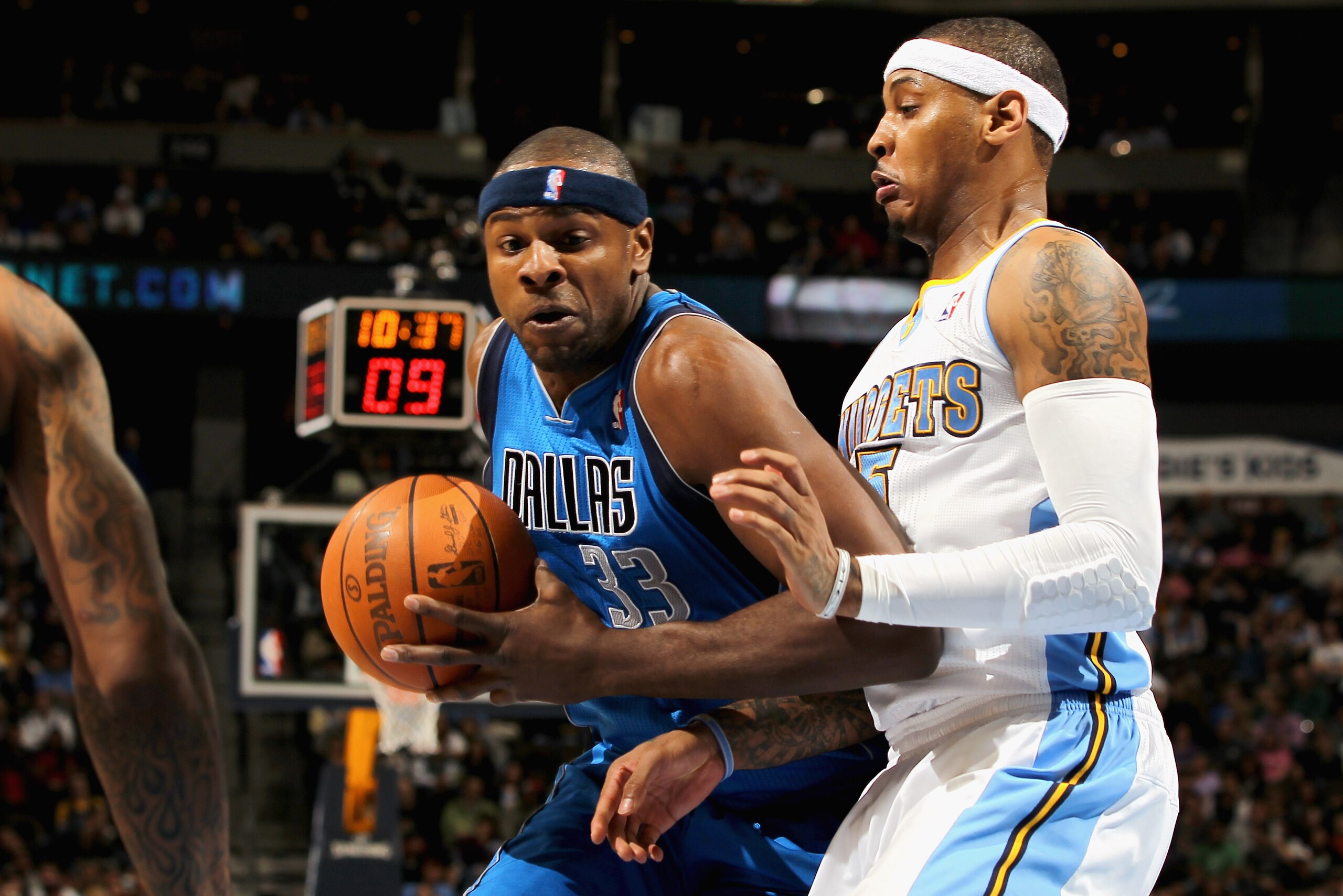 DENVER, CO - FEBRUARY 10:  Brendan Haywood #33 of the Dallas Mavericks drives to the basket against Carmelo Anthony #15 of the Denver Nuggets during NBA action at the Pepsi Center on February 10, 2011 in Denver, Colorado. NOTE TO USER: User expressly ackn