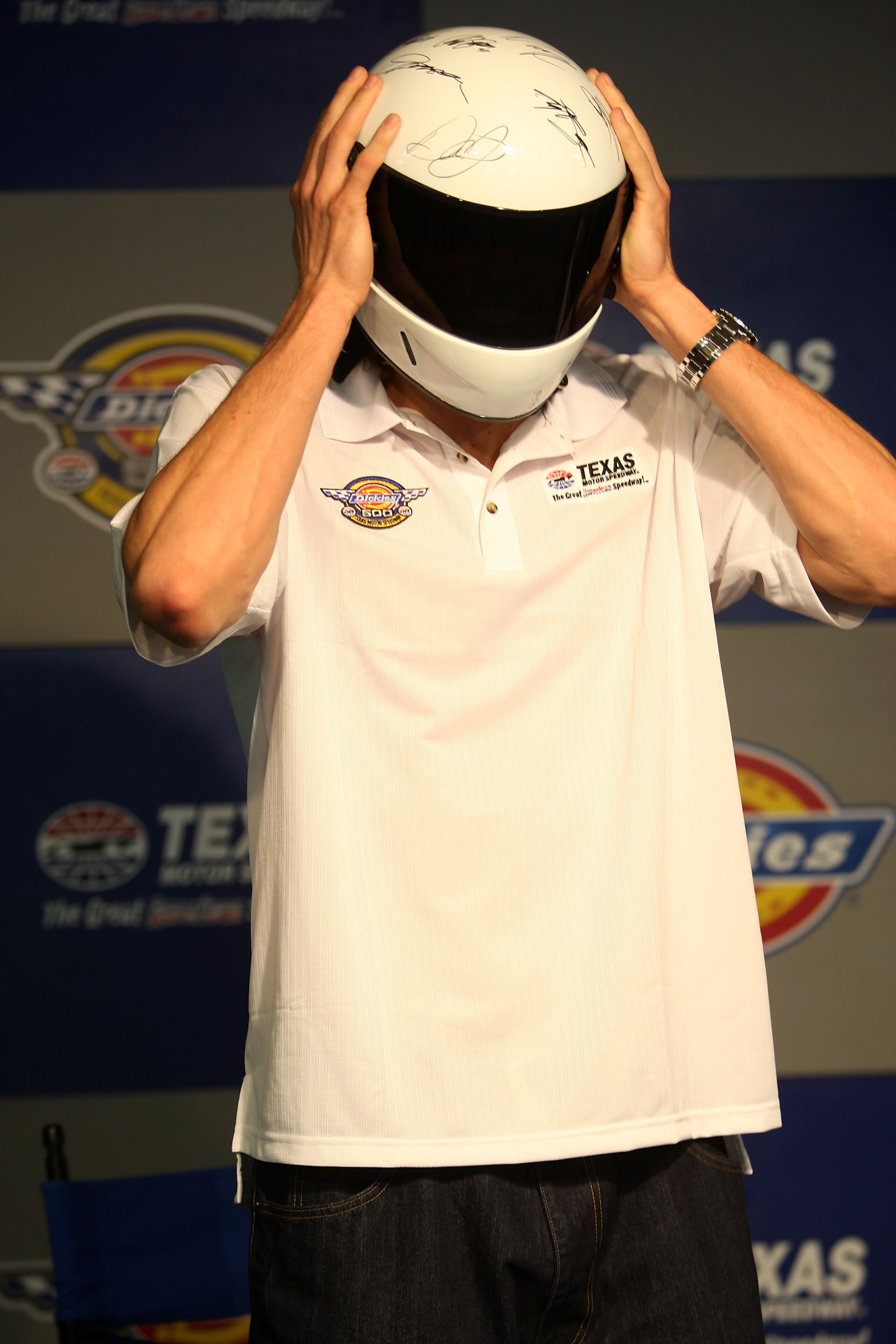 FORT WORTH, TX - NOVEMBER 04: Dirk Nowitzki of the Dallas Mavericks puts on a racing helmet during a press conference announcing him as the Grand Marshall during the NASCAR Nextel Cup Series Dickies 500 at Texas Motor Speedway on November 4, 2007 in Fort