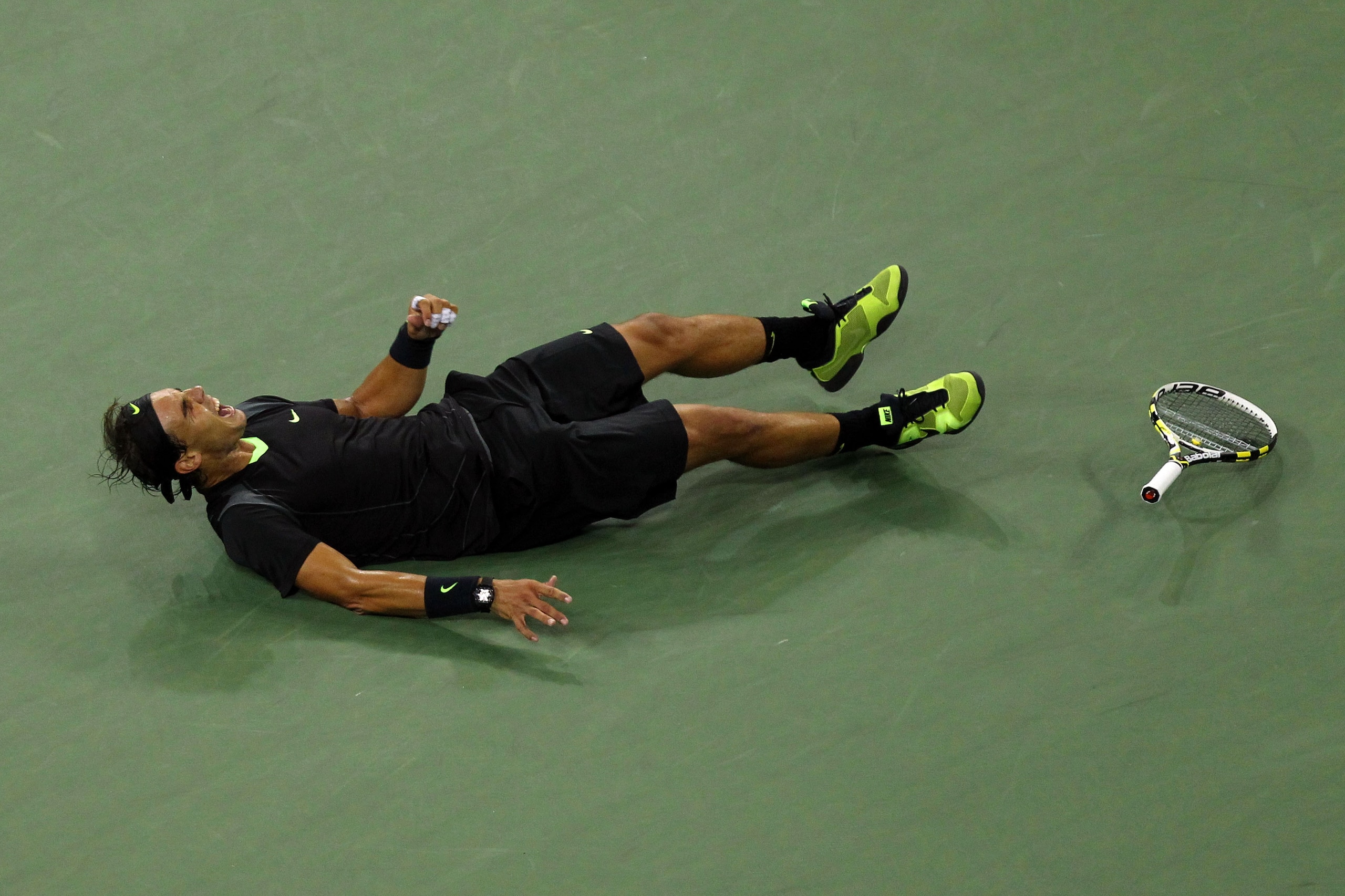 NEW YORK - SEPTEMBER 13:  Rafael Nadal of Spain rolls on the ground in celebration of his win over Novak Djokovic of Serbia during their men's singles final on day fifteen of the 2010 U.S. Open at the USTA Billie Jean King National Tennis Center on Septem