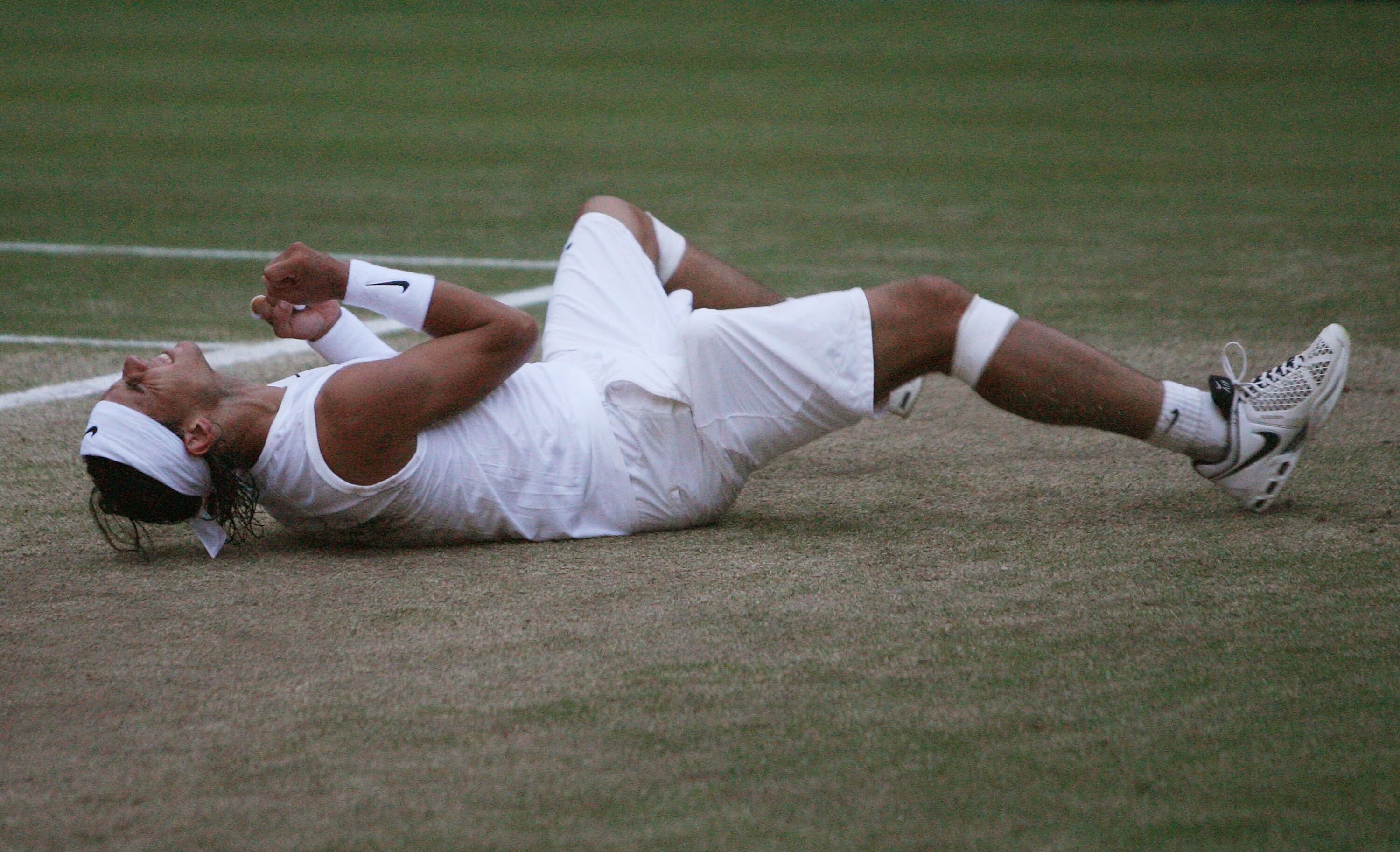 LONDON - JULY 06:  Rafael Nadal of Spain celebrates winning match point and the Championship during the men's singles Final match against Roger Federer of Switzerland on day thirteen of the Wimbledon Lawn Tennis Championships at the All England Lawn Tenni