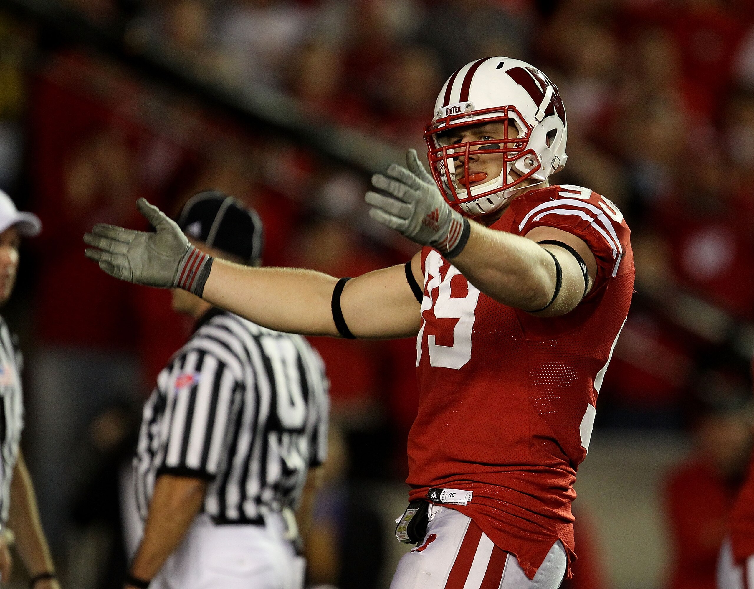 MADISON, WI - OCTOBER 16: J.J. Watt #99 of the Wisconsin Badgers encourages the crowd during a game against the Ohio State Buckeyes at Camp Randall Stadium on October 16, 2010 in Madison, Wisconsin. Wisconsin defeated Ohio State 31-18. (Photo by Jonathan 