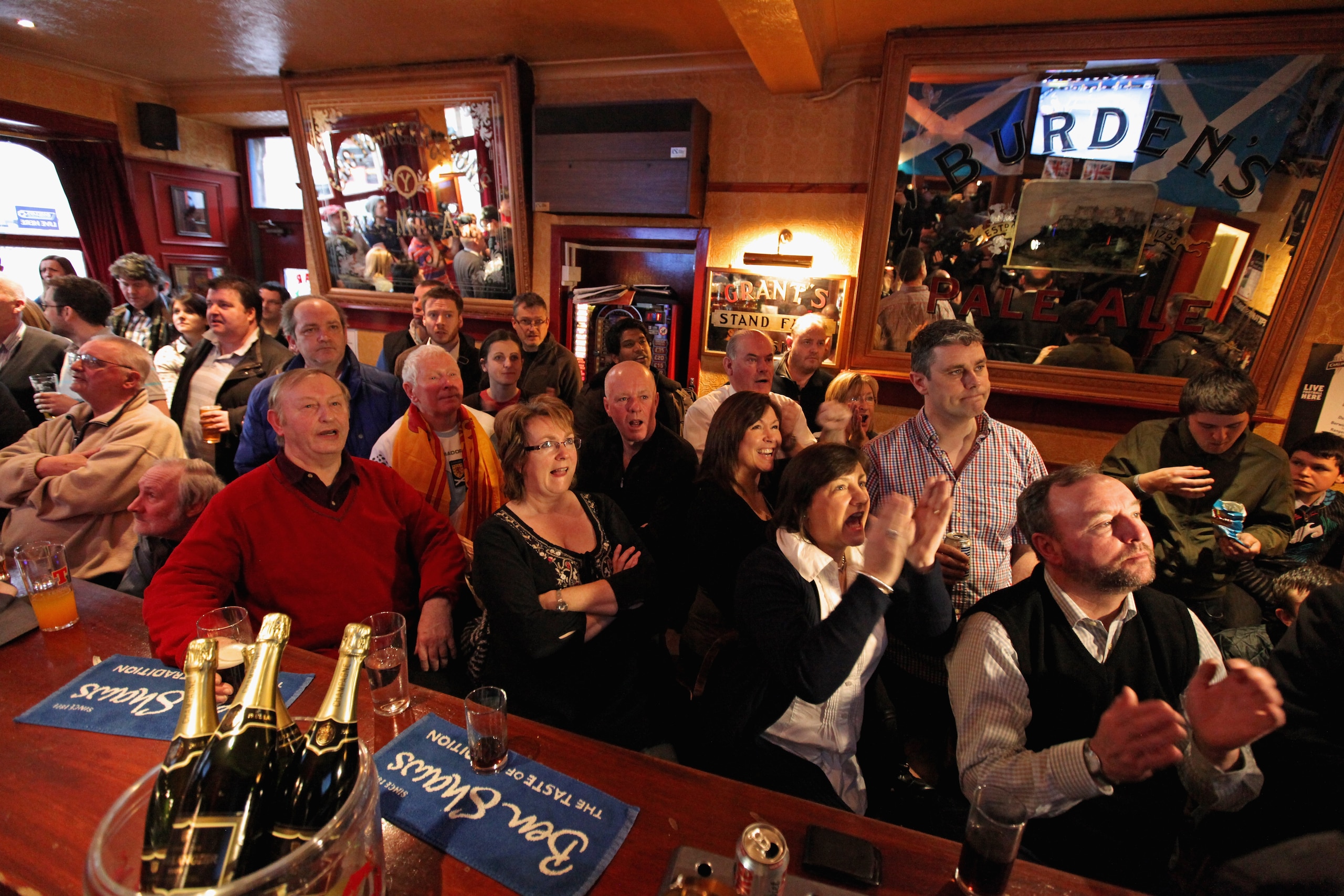 DUNBLANE, SCOTLAND - JANUARY 30:  Fans of tennis player Andy Murray, react as they watch his Australian Open final match against Novak Djokivic, in the bar of The Dunblane Hotel in his hometown on January 30 2011 in Dunblane, Scotland. Andy Murray lost to