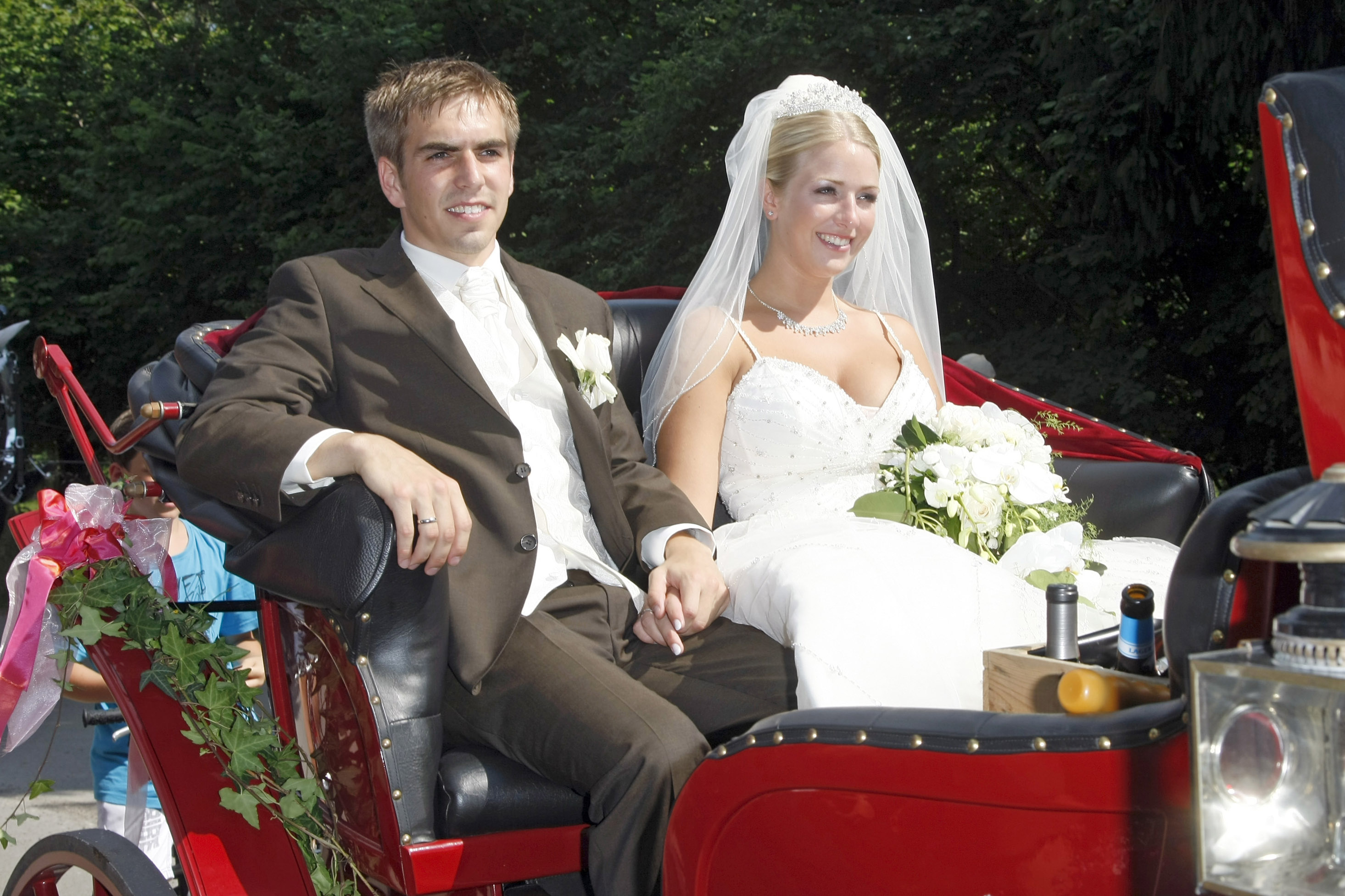 AYING, GERMANY - JULY 14:  FC Bayern Muenchen football player Philipp Lahm and his wife Claudia Schattenberg leave their church wedding at the Sankt Emmerans church on July 14, 2010 in Kleinhelfendorf near Aying, Germany.  (Photo by Florian Seefried/Getty