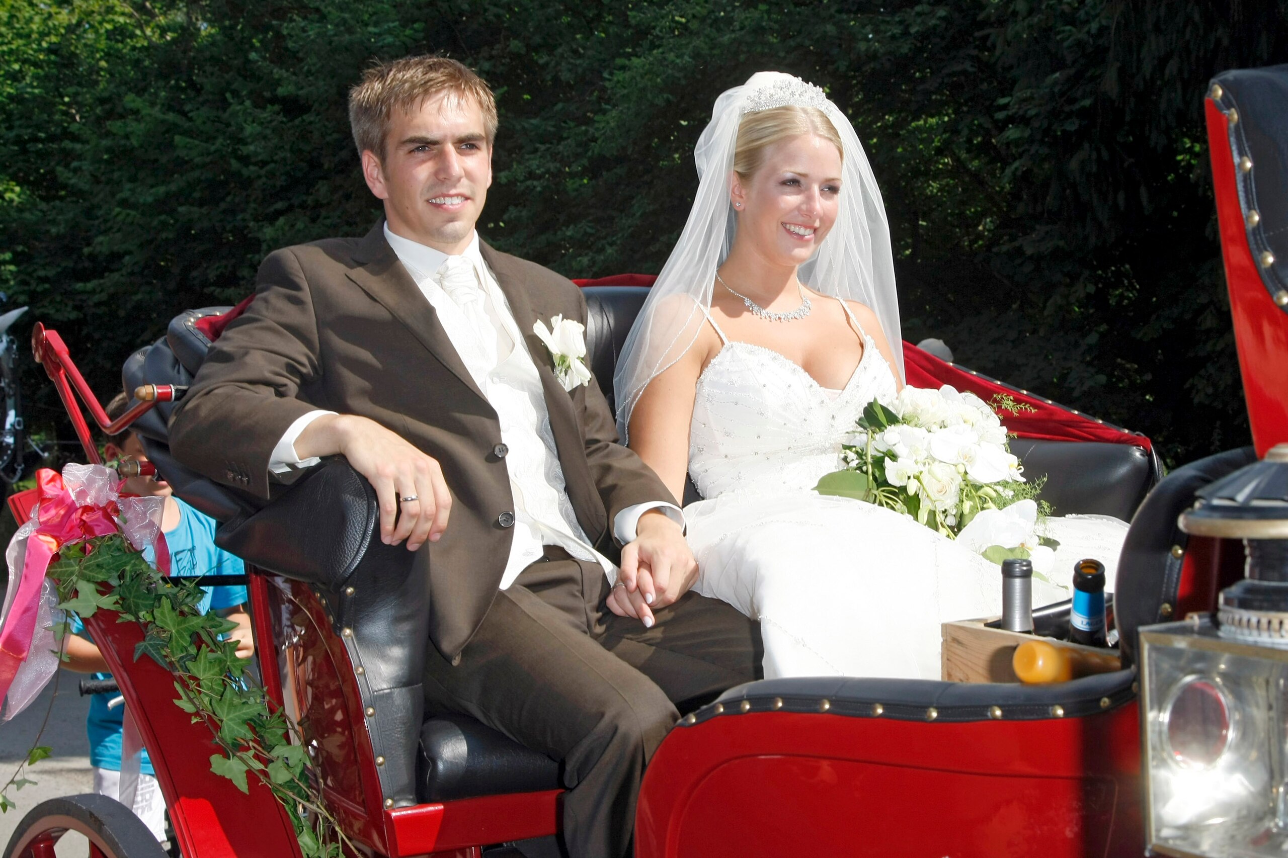 AYING, GERMANY - JULY 14:  FC Bayern Muenchen football player Philipp Lahm and his wife Claudia Schattenberg leave their church wedding at the Sankt Emmerans church on July 14, 2010 in Kleinhelfendorf near Aying, Germany.  (Photo by Florian Seefried/Getty